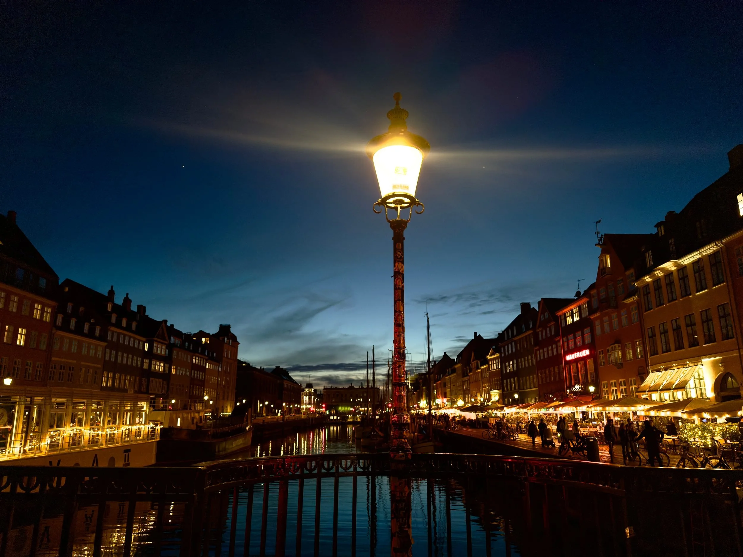 A street lamp against the coloured façades of Nyhavn, Copenhagen.