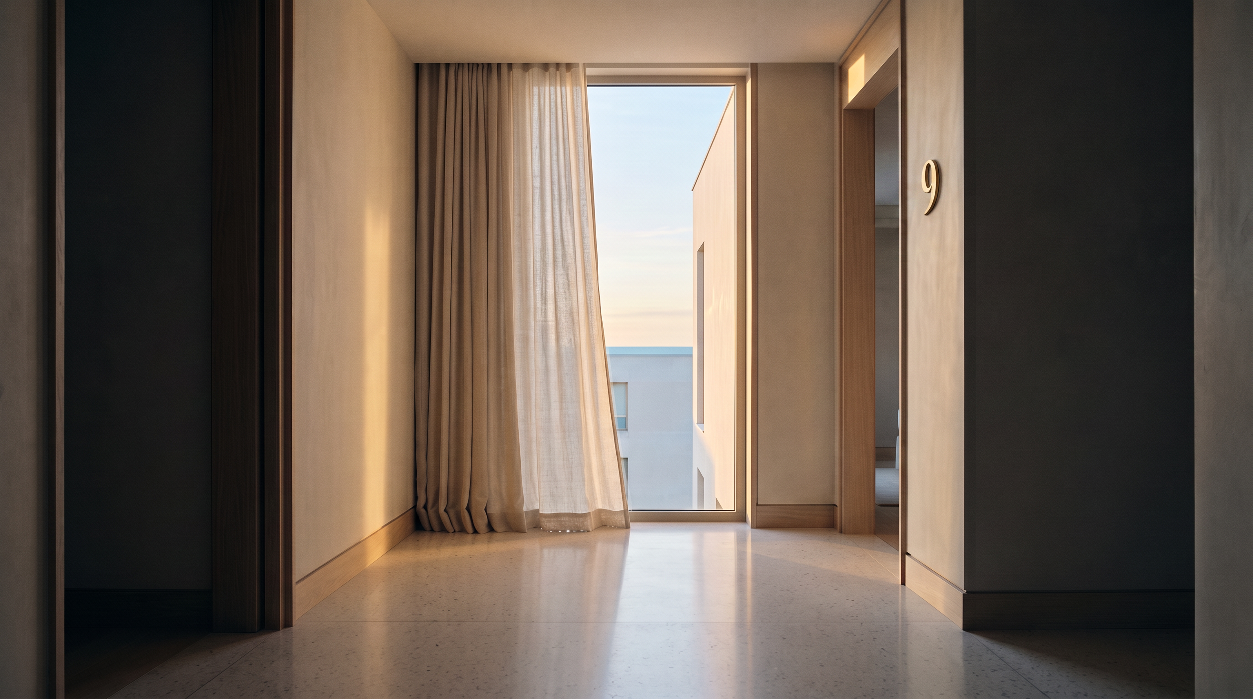 View through a doorway showing an open curtain leading to a balcony with a view of the sky and neighboring building.