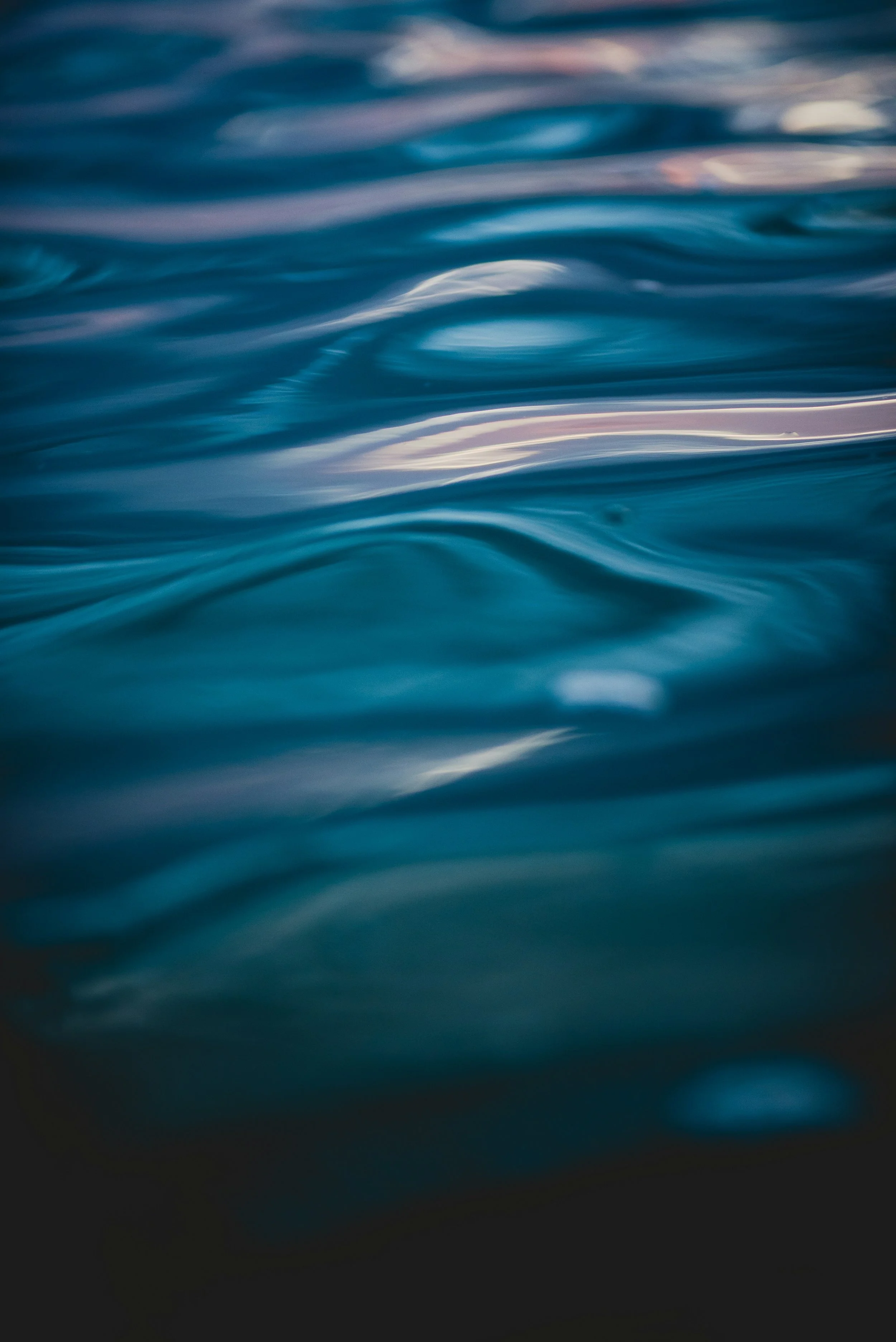 Close-up of calm blue water with gentle ripples and reflections.