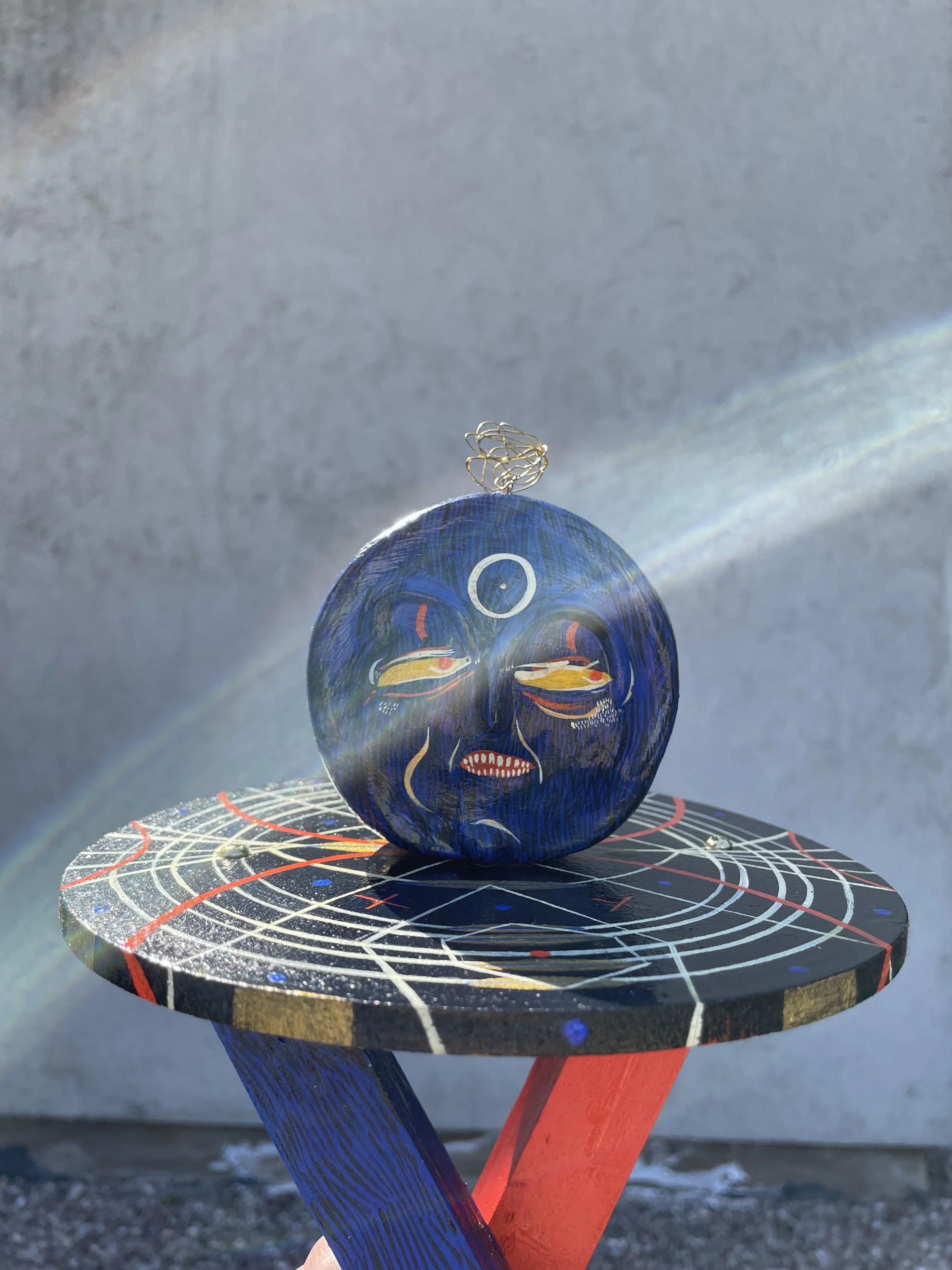 'ELECTROMAGNETISM' mid stride with a double face.  A physical representation of the unseen forces which influence us and move us forward.  Red and blue suggest the duality of the opposing magnetic charges and his painted collar depicts a diagram of r