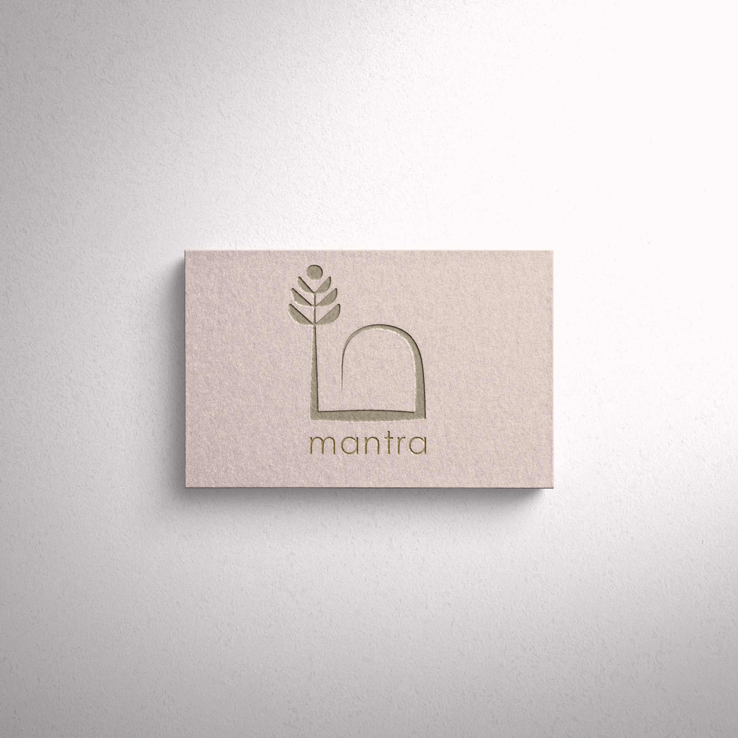 A beige business card with a minimalistic logo representing a stylized plant or wheat stalk and the word" mantra" written below in lowercase letters, placed on a light gray textured background.