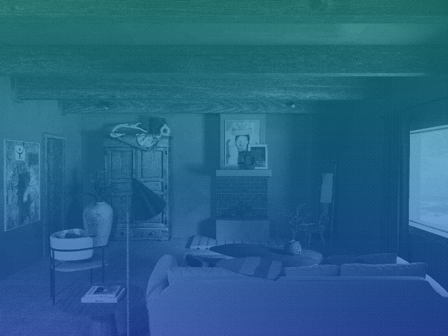 Living room with nautical decor, including a fish sculpture hanging from the ceiling, framed artwork, a couch, coffee table, and a screen on the wall.