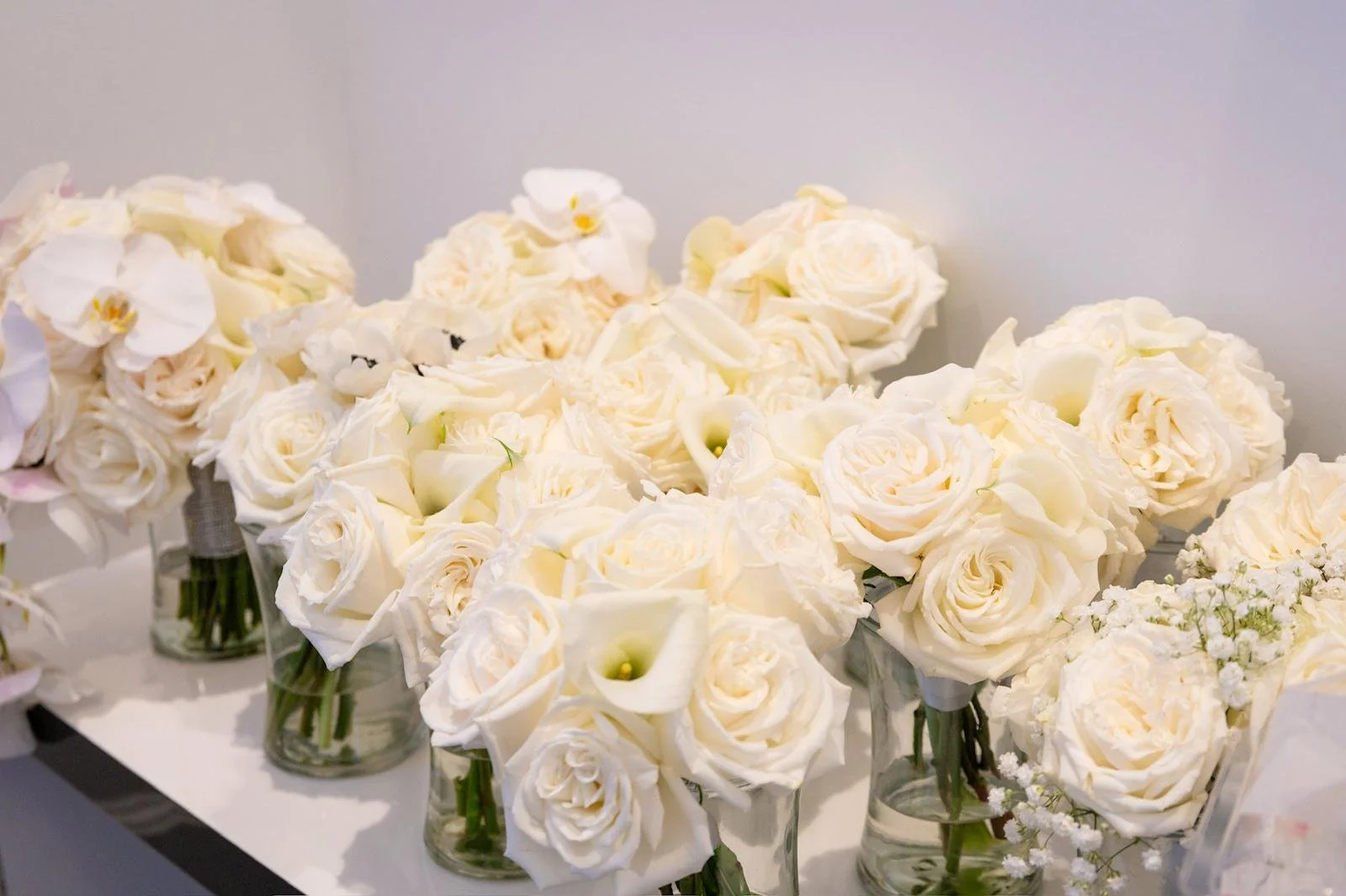White rose bouquets in glass vases