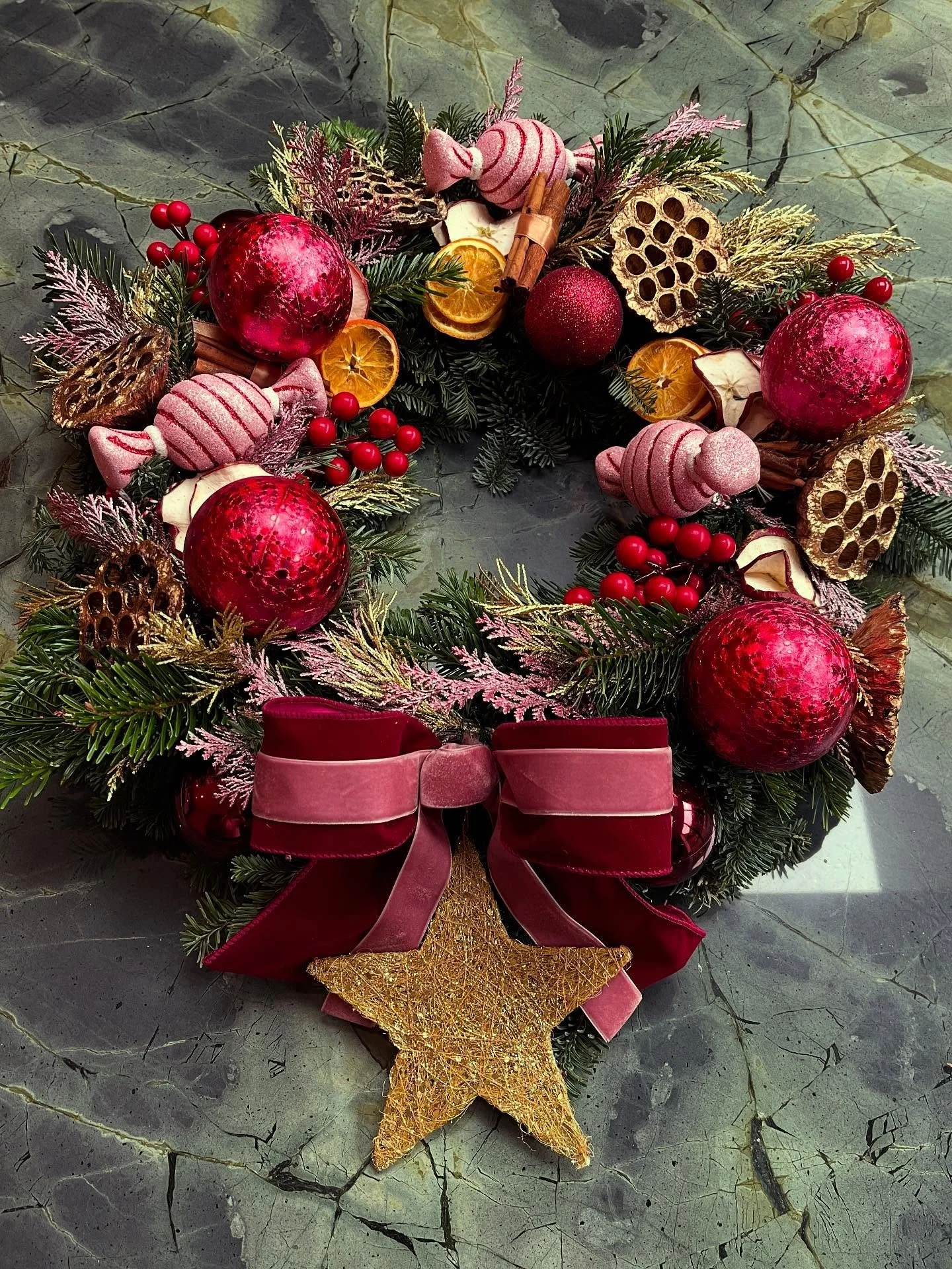 The St-ROSE Christmas Collection Has Arrived - Discover our Candy Blush Christmas Wreath.

A luxury blue fir Christmas wreath adorned with candy shaped decorations, red berry baubles, dried orange and apple slices, and cinnamon for warmth, finished w