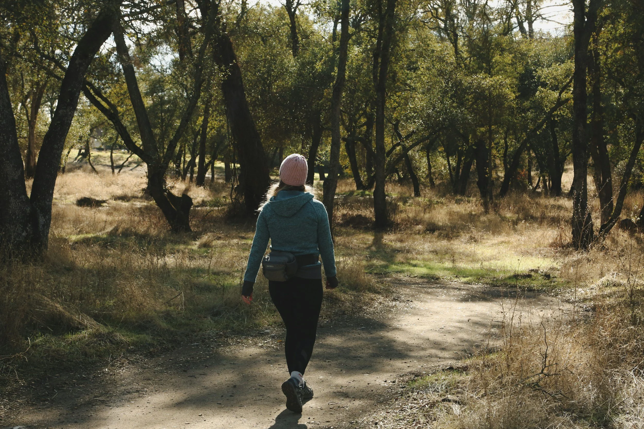 woman hiking through the woods