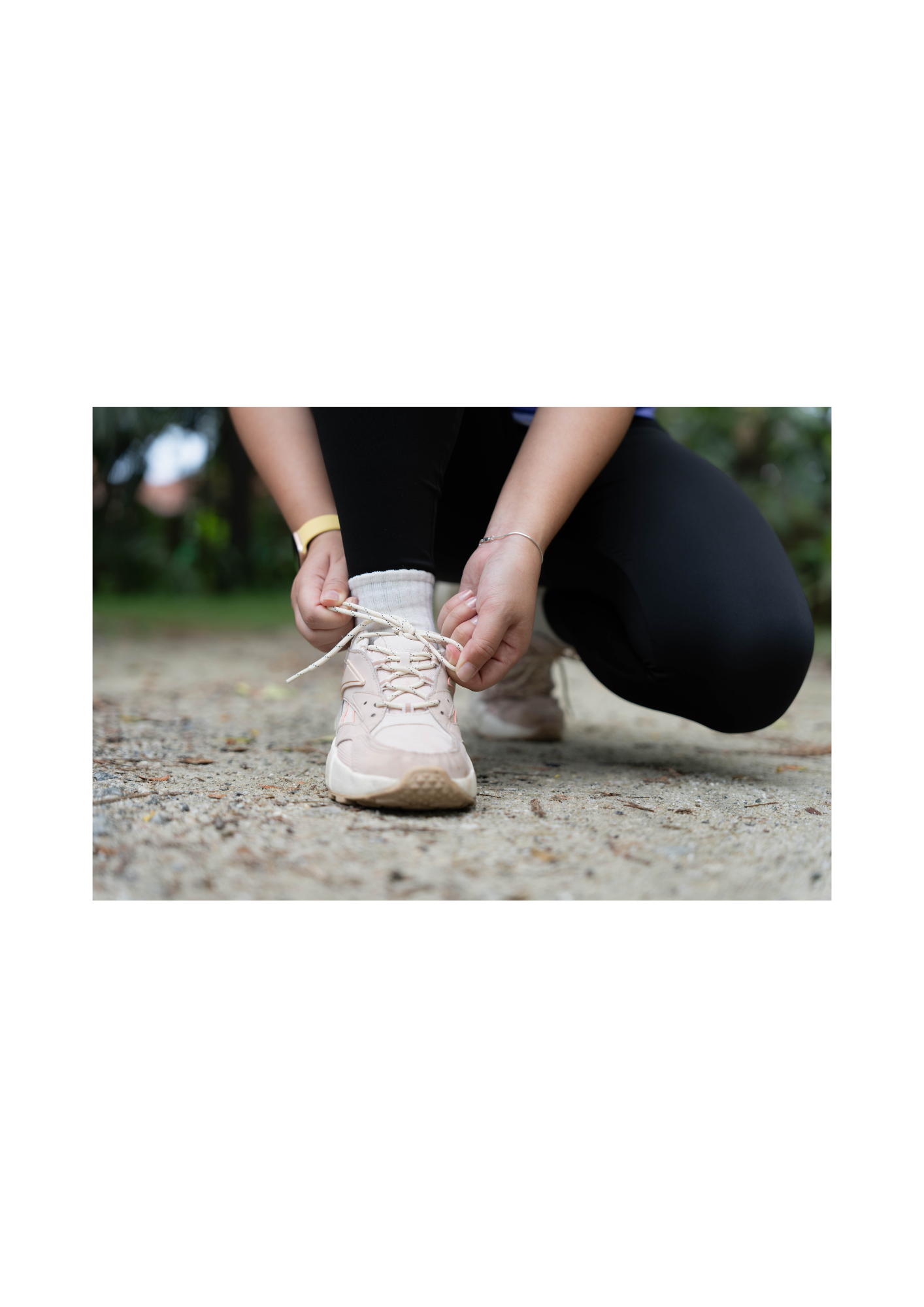 Midlife woman tying her running shoe before a workout, symbolizing a metabolism-supportive approach to weight and body changes in menopause.
