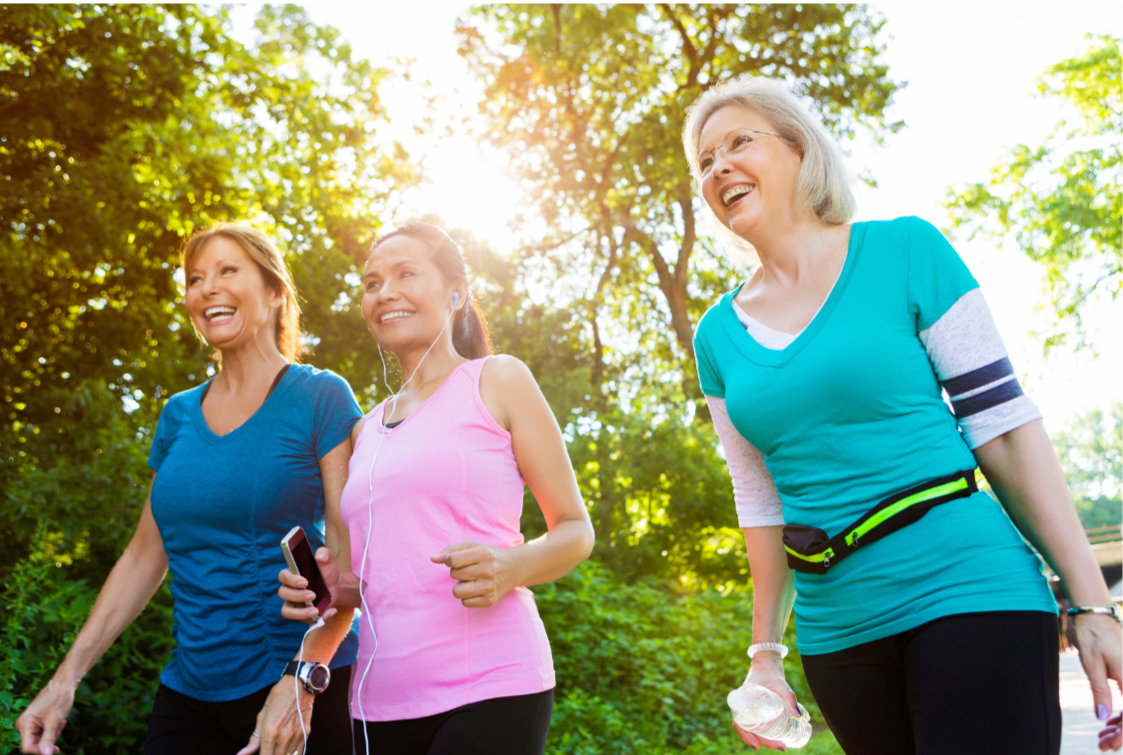 midlife women walking outdoors together, representing a sustainable, joy-centered approach to exercise in midlife.