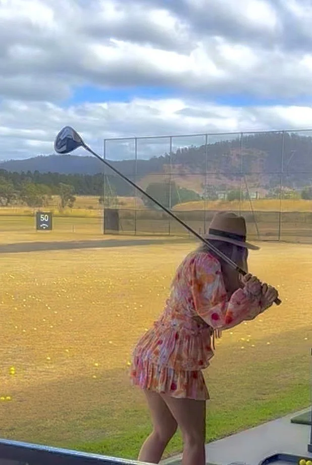 Woman at a driving range in Hobart.