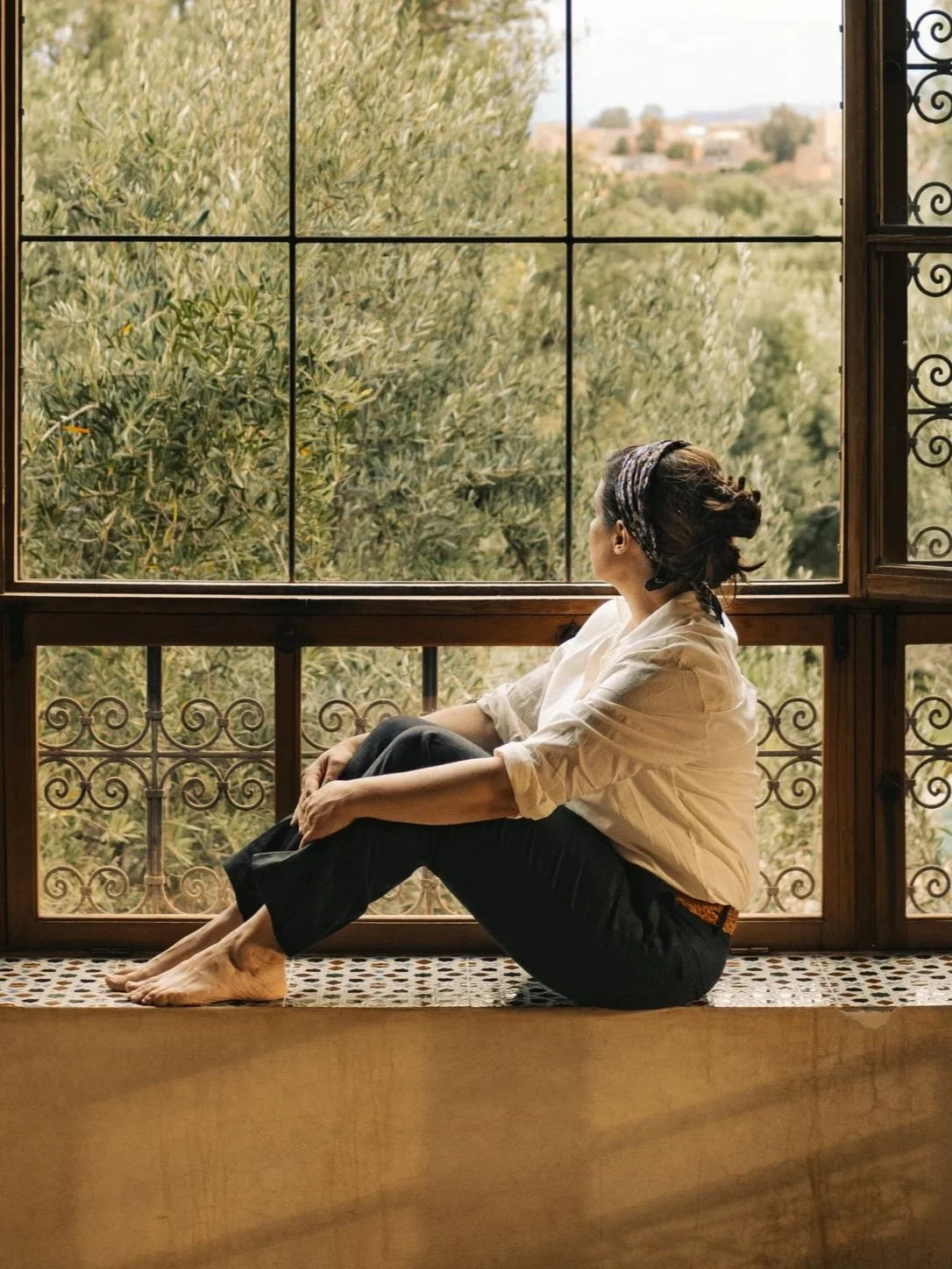 Interior living room at Berber Lodge near Marrakech, guest looking out to countryside through a large window