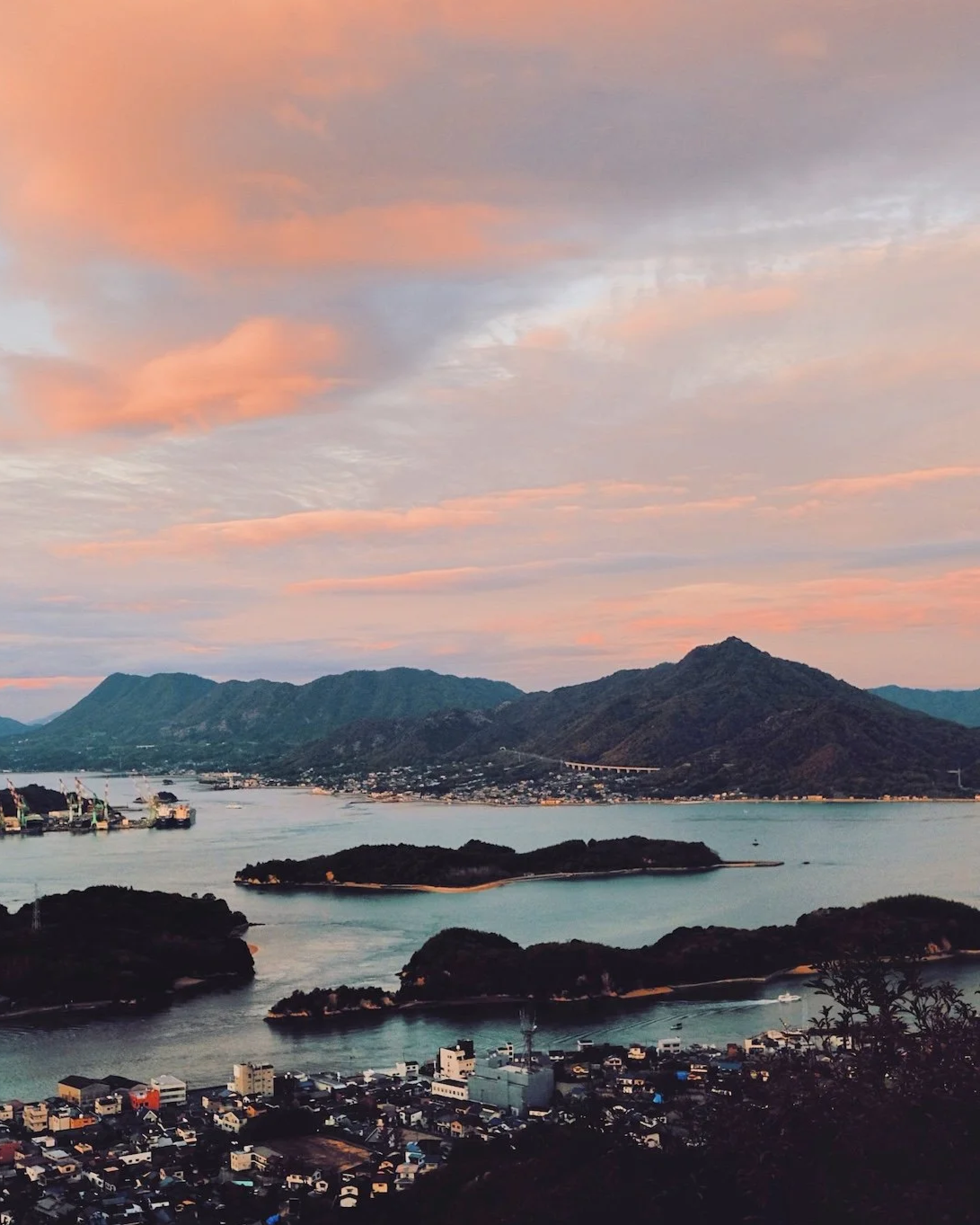 Japan — Inner Japan × Sensory Travel: sunset over a city by the sea