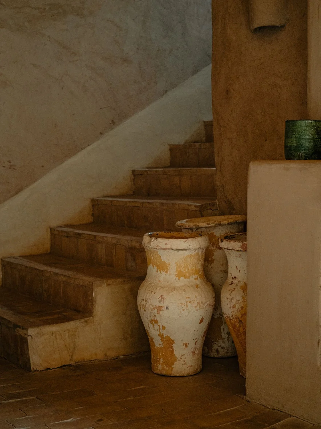 Interior corner at Berber Lodge near Marrakech, clay pottery and earthen decoration in a minimal, textured space
