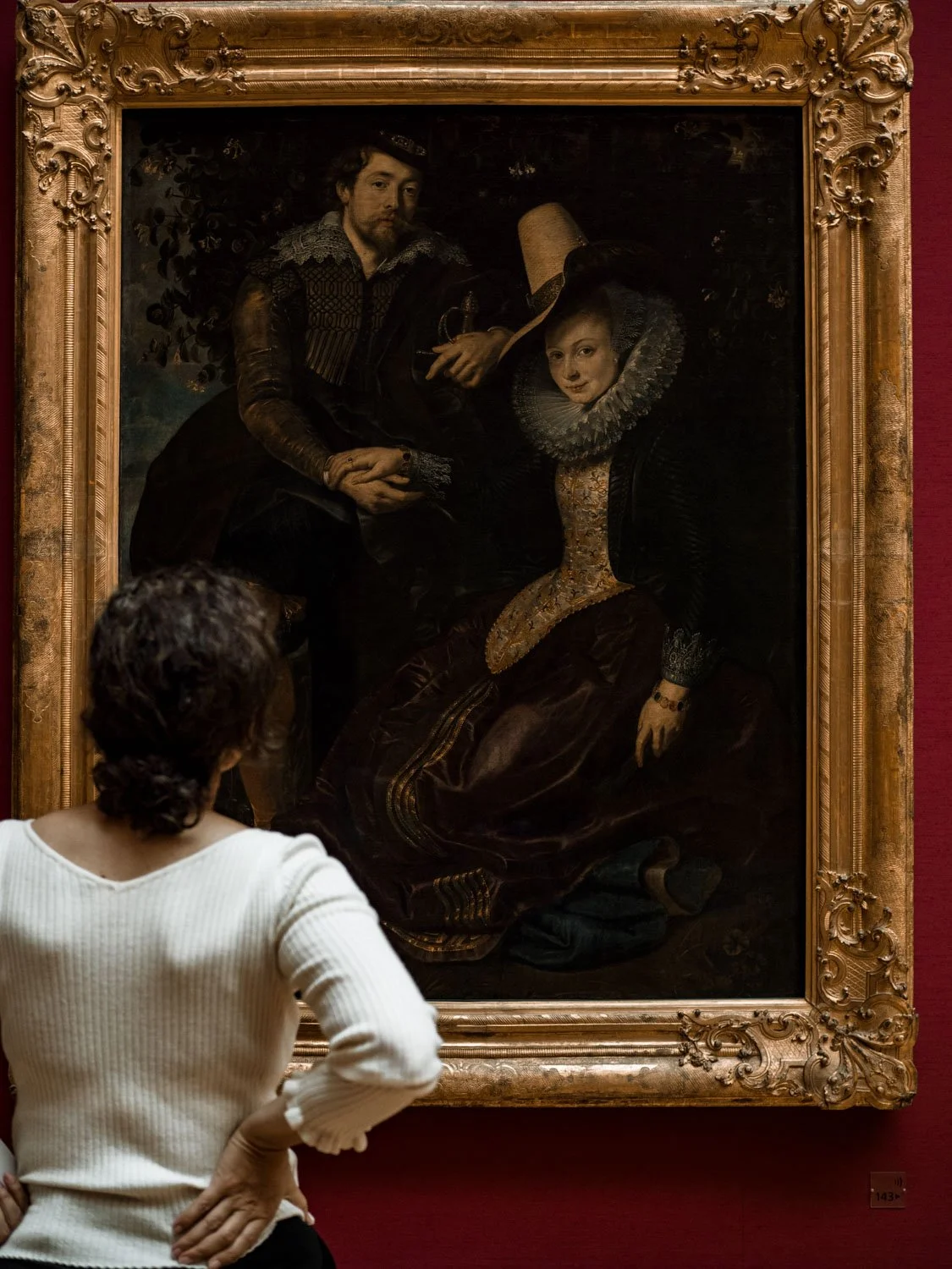 Woman viewing a painting at the Alte Pinakothek museum, Munich, Germany