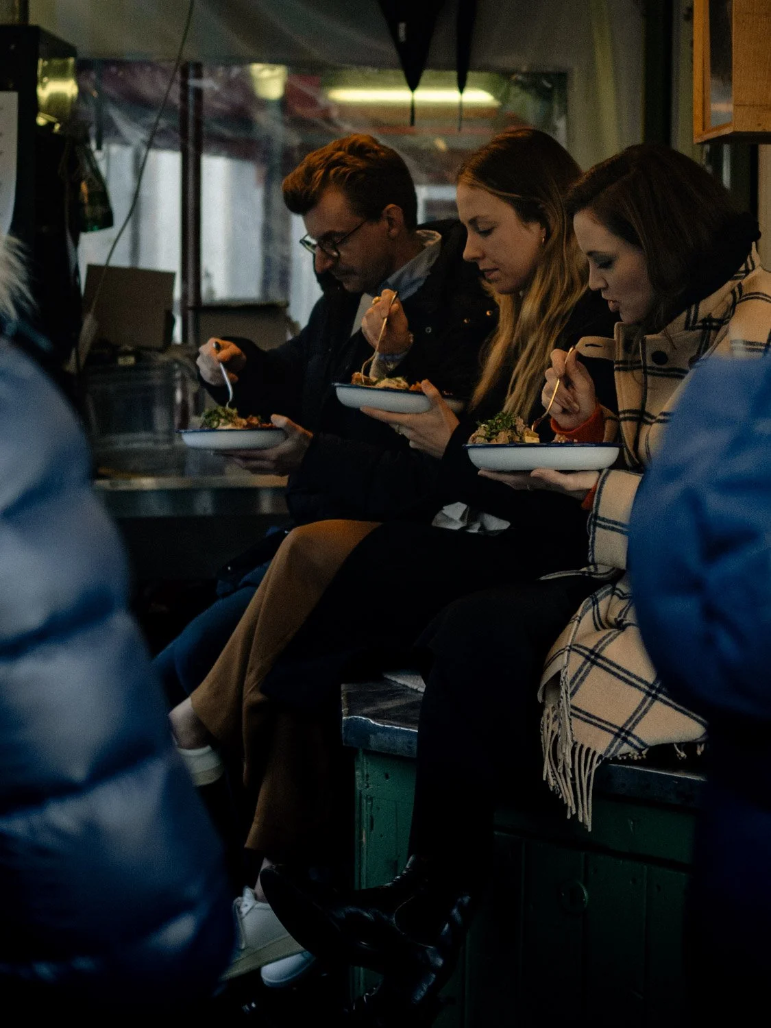 Locals enjoying lunch at a restaurant in Viktualienmarkt in winter, Munich