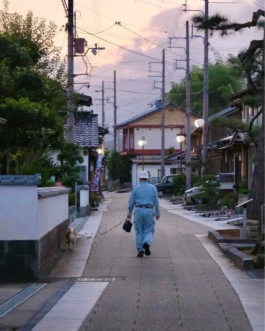 Japan — Inner Japan × Sensory Travel: a local walking his dog on a calm street