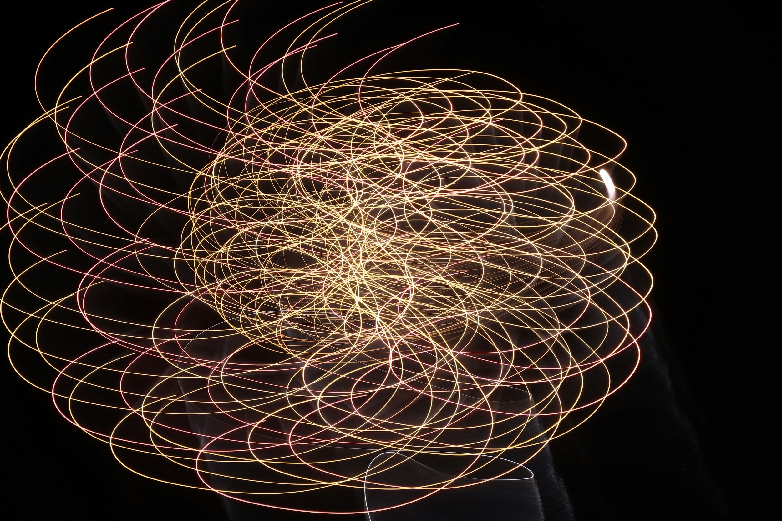Interwoven light trails forming a complex, swirling pattern, symbolizing the many pathways of a neurodivergent mind.