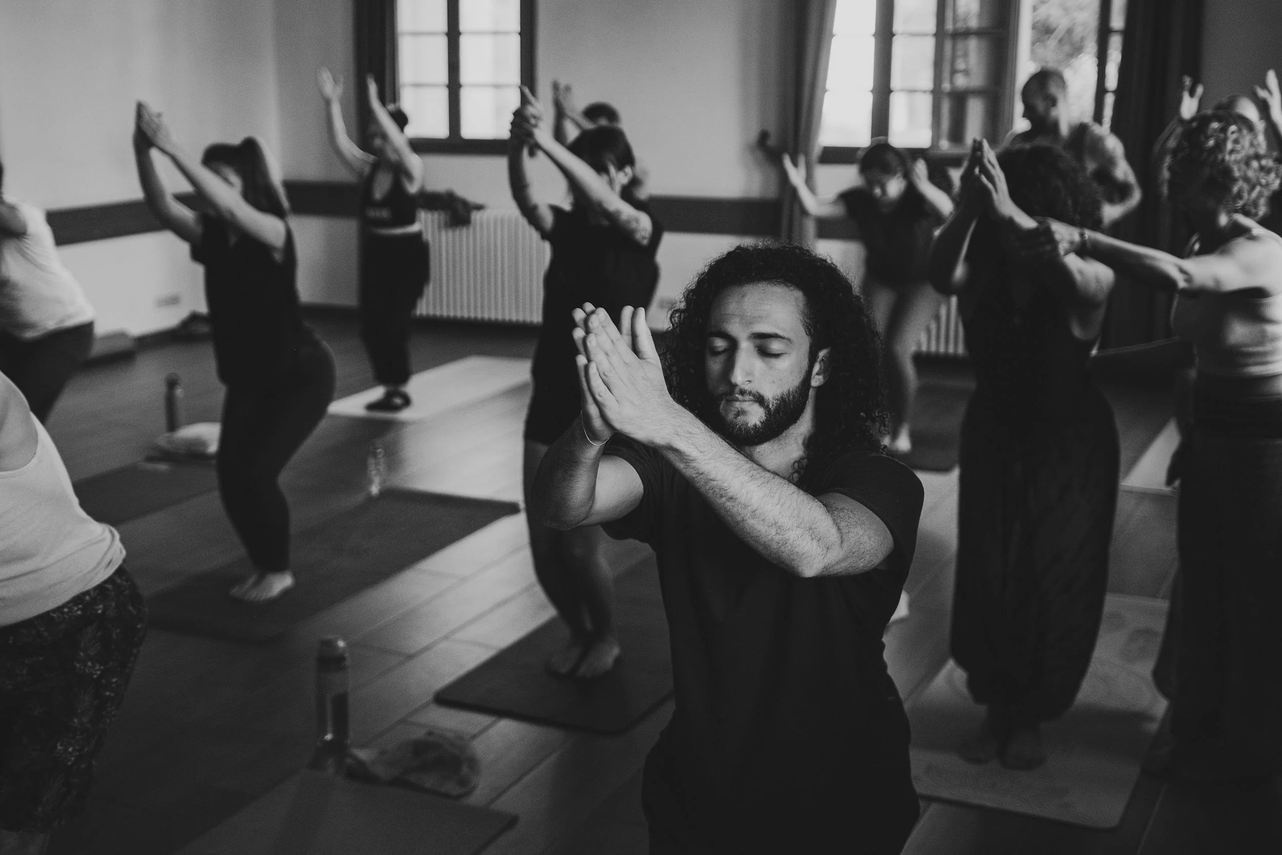 Yoga teacher leading a group yoga class.