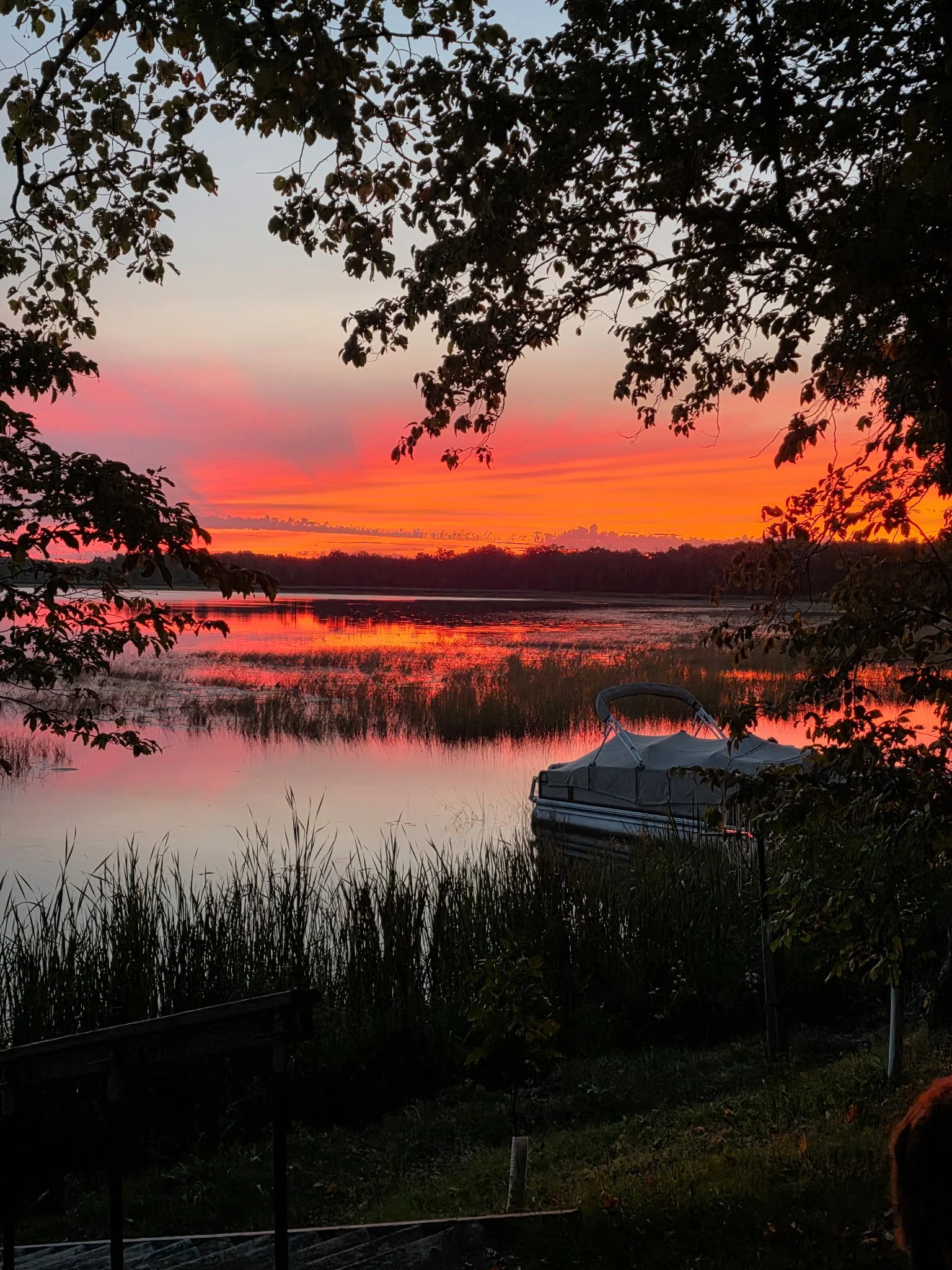 Colorful sunset reflected across a quiet Minnesota lake.