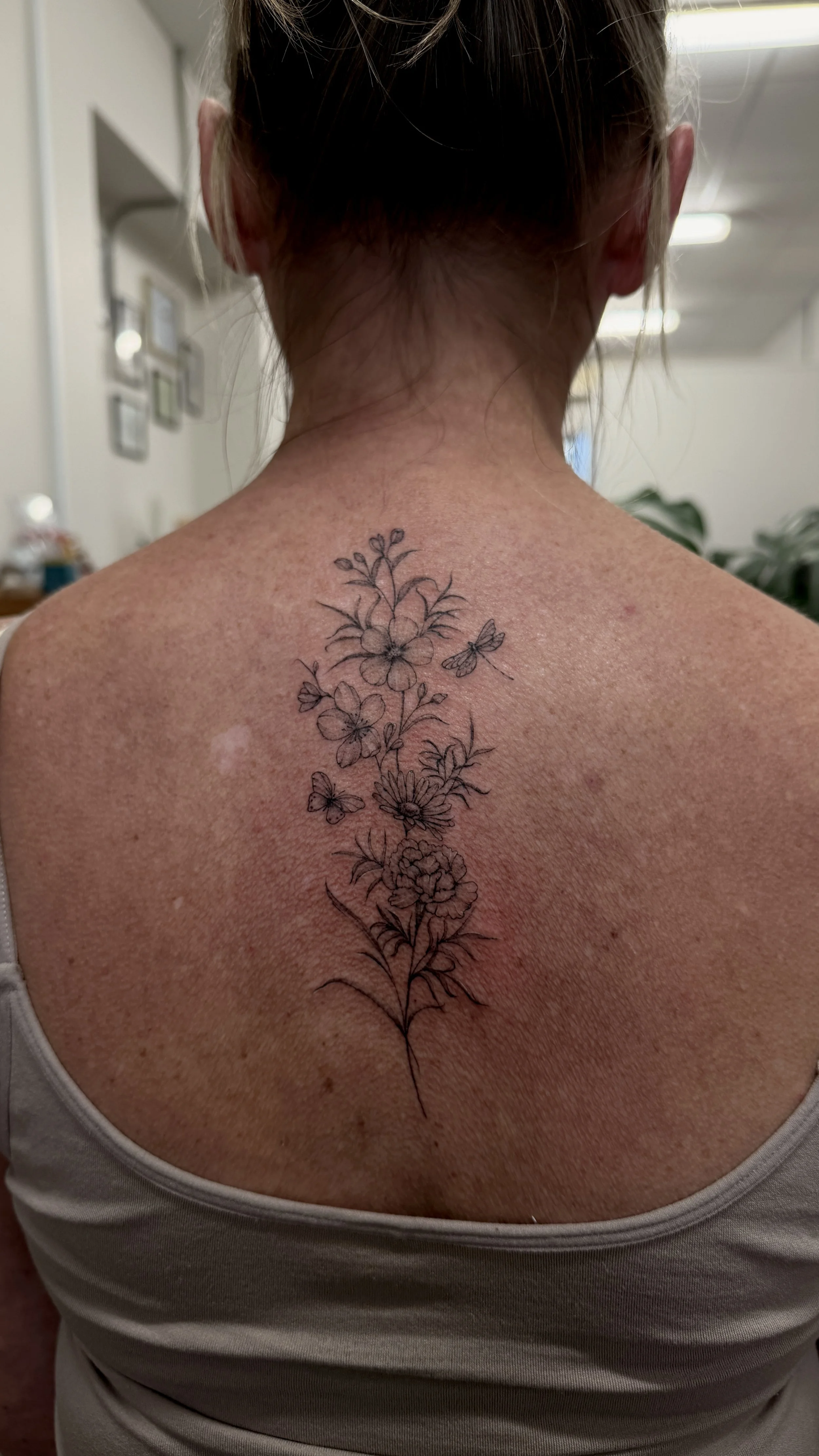  fineline birth flower back tattoo.jpg