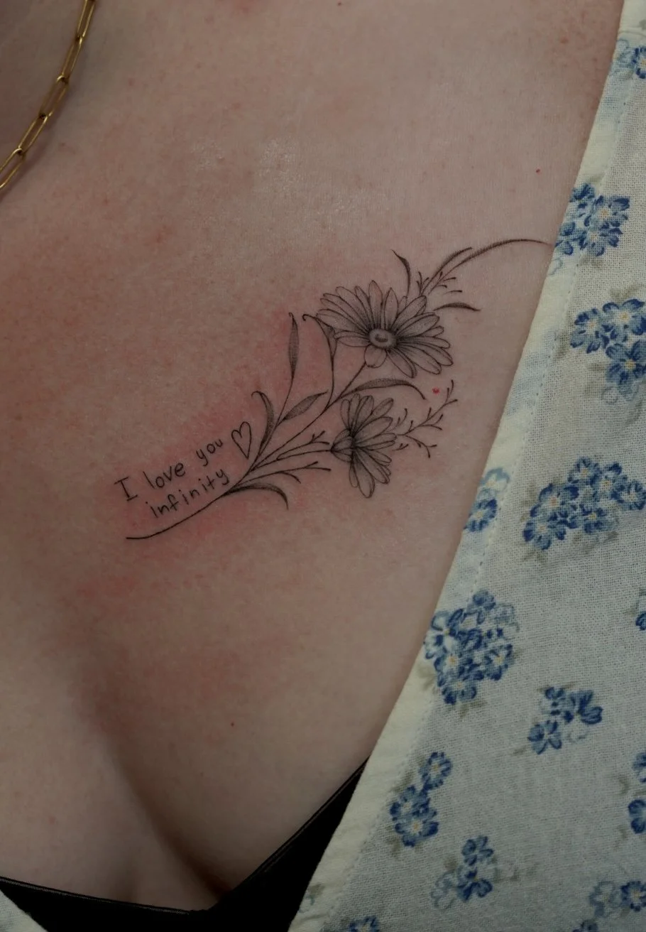 fineline daisy collarbone tattoojpg.jpg