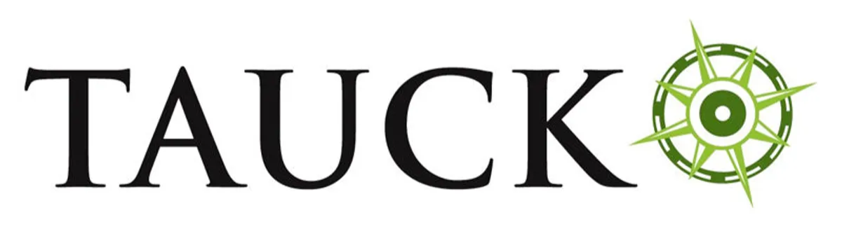 The word "TAUCK" in black font with a green compass rose icon to the right.