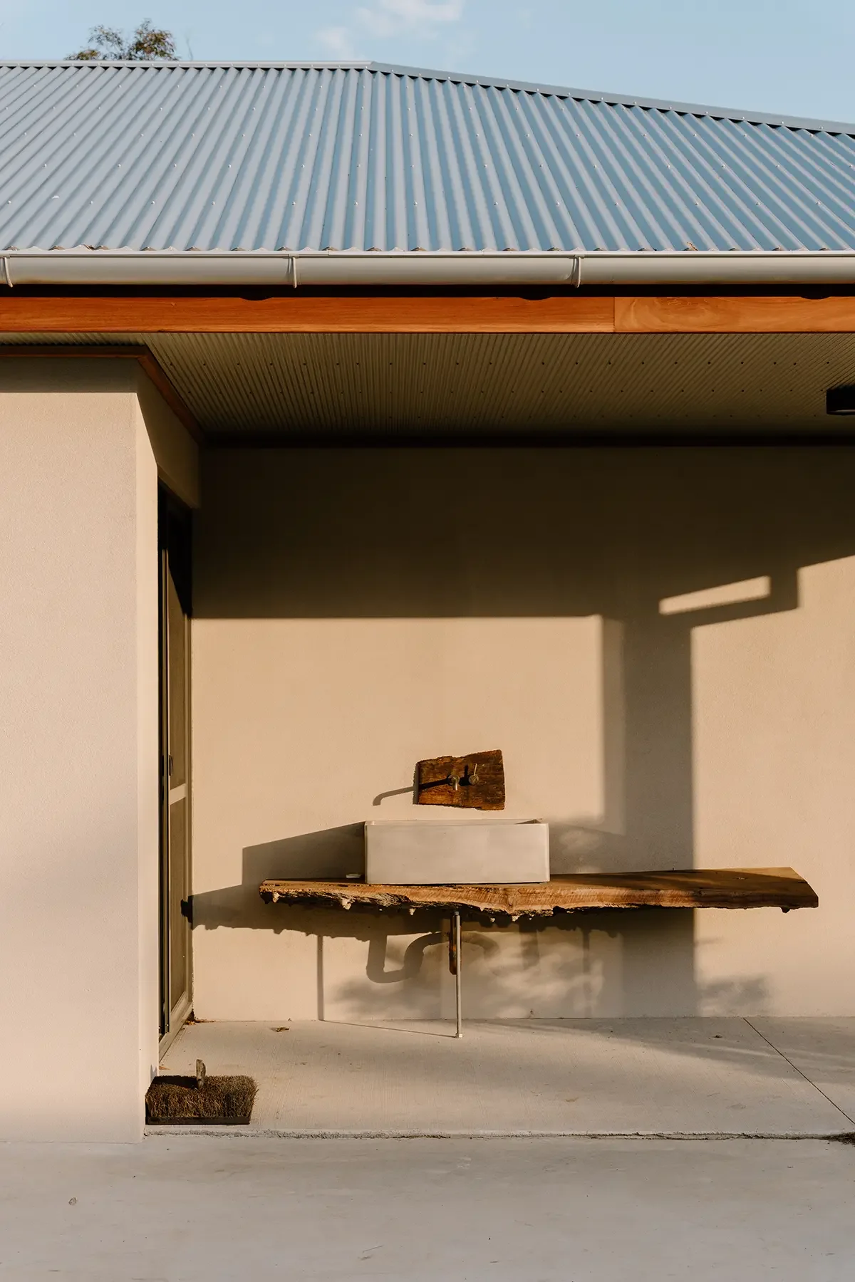 external basin sitting on wooden slab bench