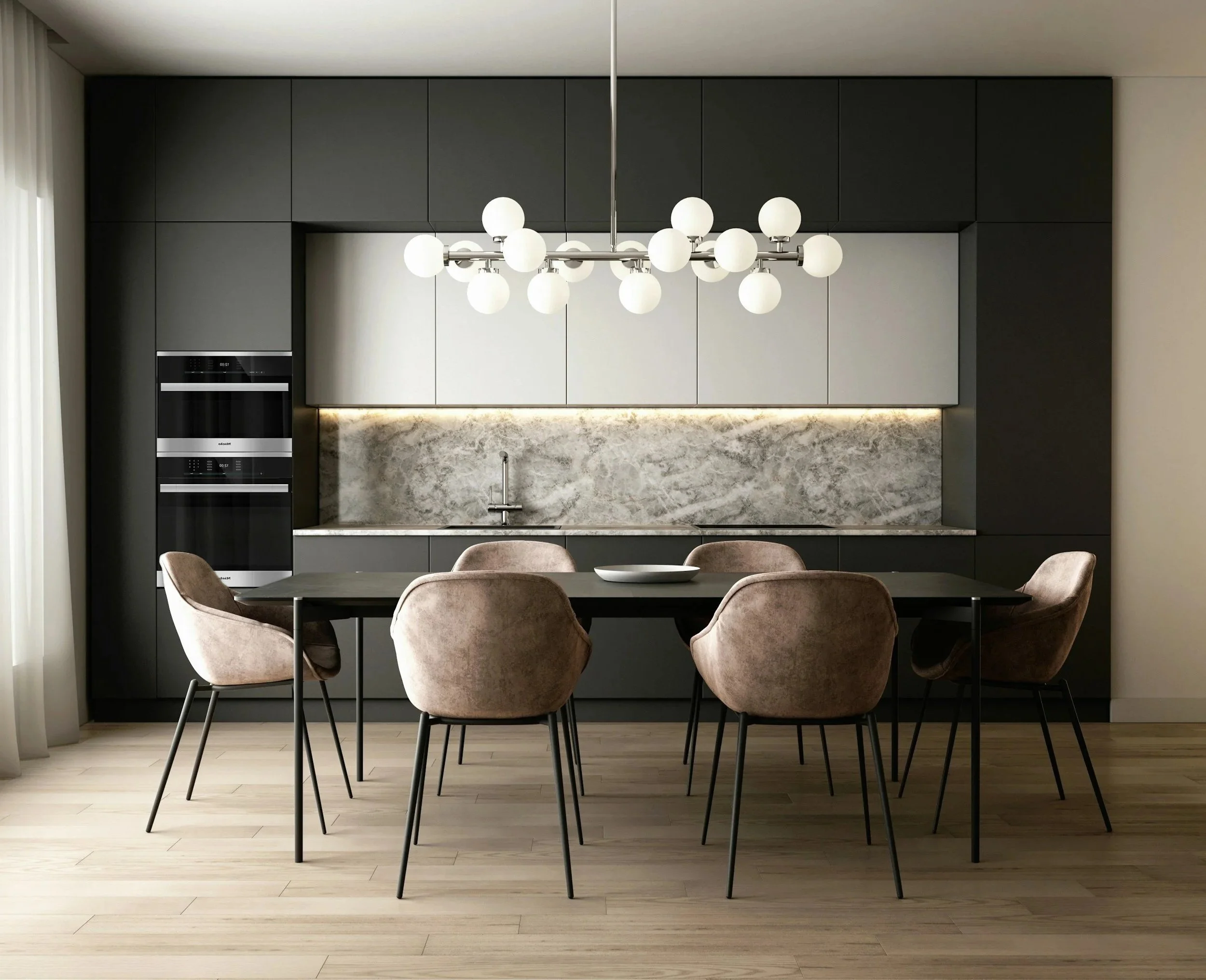 Modern kitchen with bar seating, black and white cabinetry, marble backsplash, and a chandelier with multiple spherical lights.