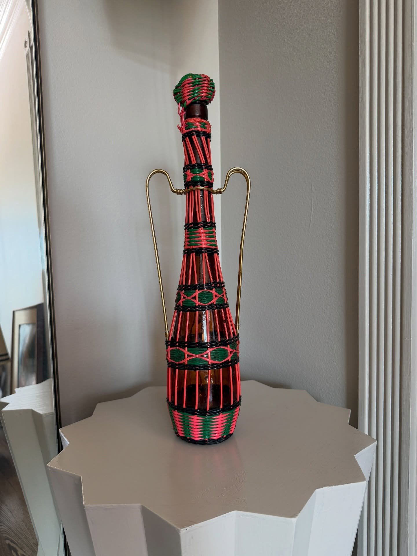 Popular in the 60s-70s, this Mediterranean craft of wrapping vintage glass wine bottles in handwoven plastic wicker is called Spanish Scoubidou. 

This handmade, one of a kind piece is now available in our shop at @urbanamericana. 

#shopvintage #vin