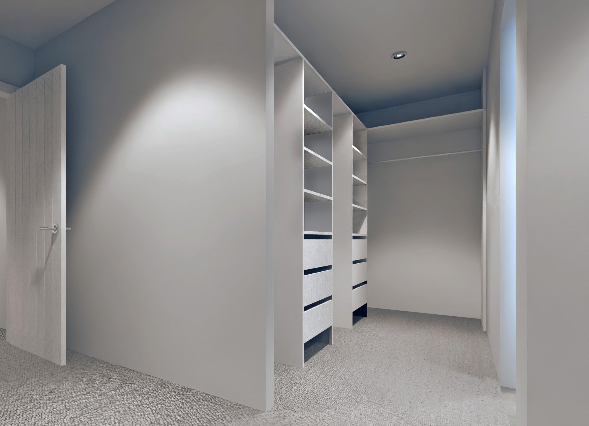 Empty walk-in closet with white shelves and drawers, beige carpet, and a door on the left.