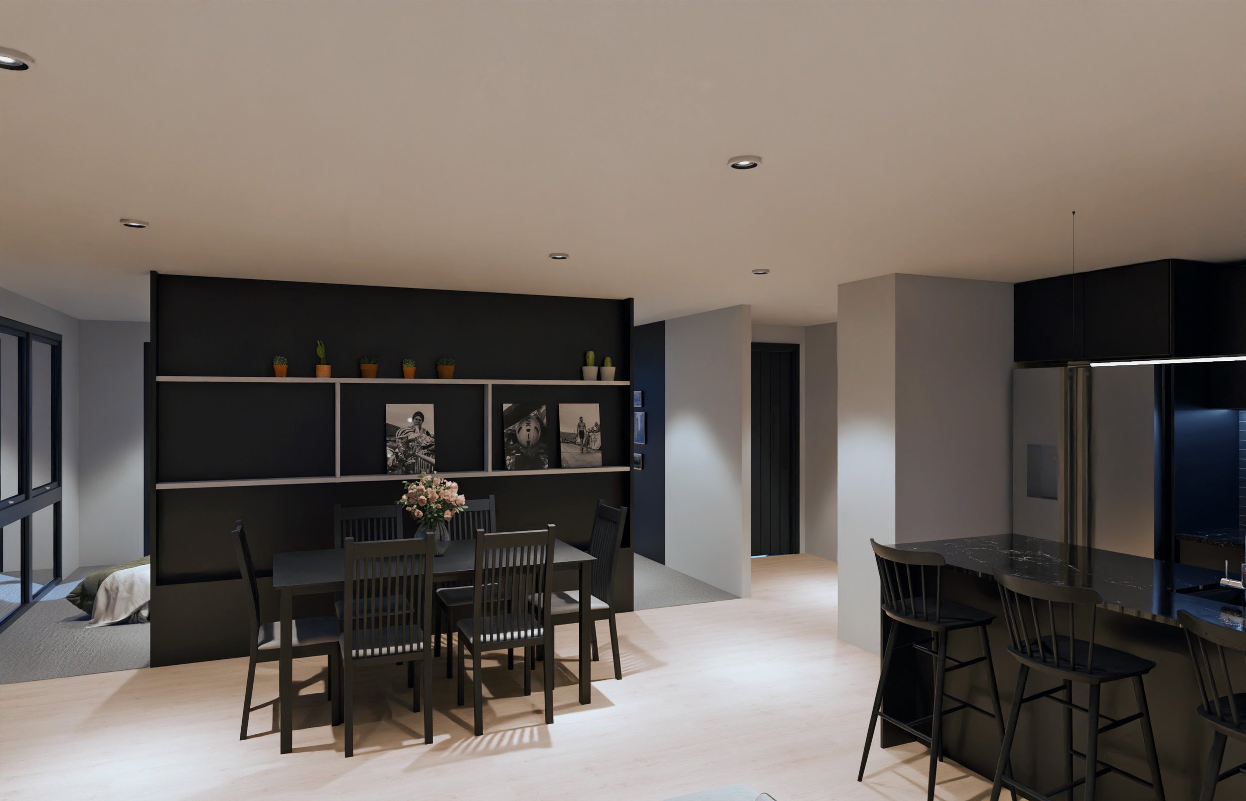Modern dining area with black dining table and chairs, black wall with white shelves holding potted plants and black-and-white photographs, adjacent kitchen with black bar stools, and a nook with a large window, light wood flooring, and neutral-color