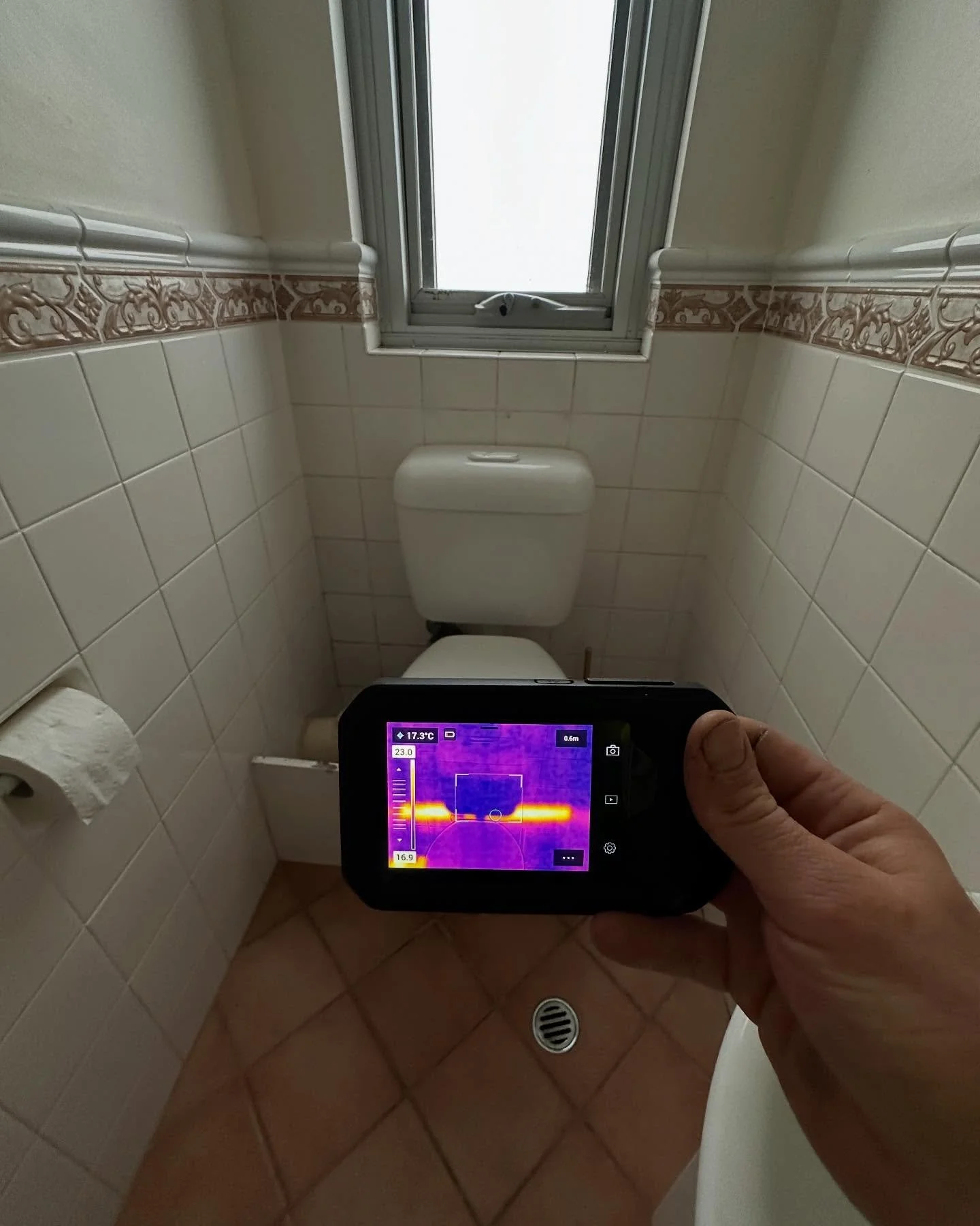 Locating a leak using the thermal camera and moisture meter on a 50mm copper drain that was chased into the wall servicing the laundry tub.