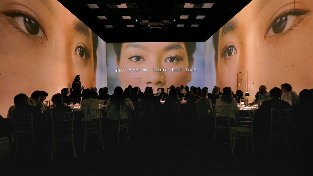 Woman looking into camera with existential question on screen