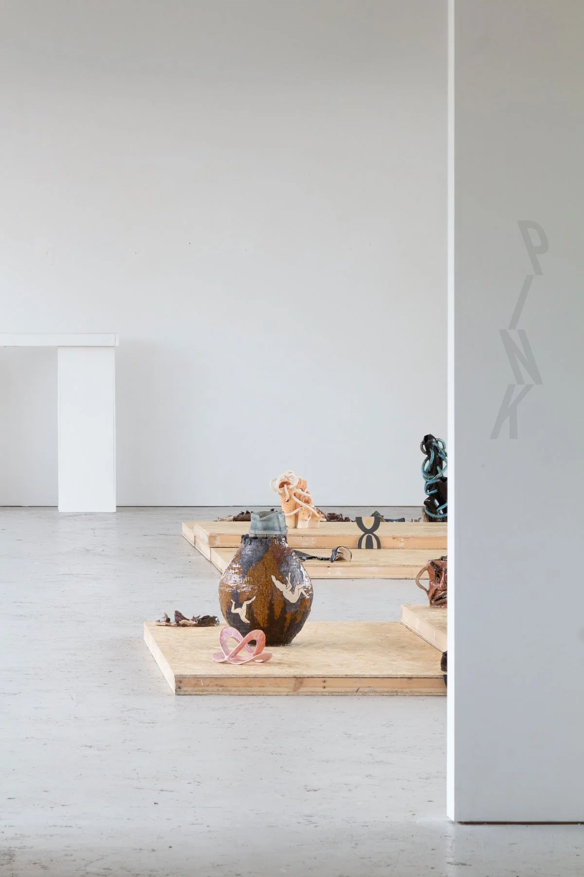 photo of an exhibition with vinyl logo on gallery wall