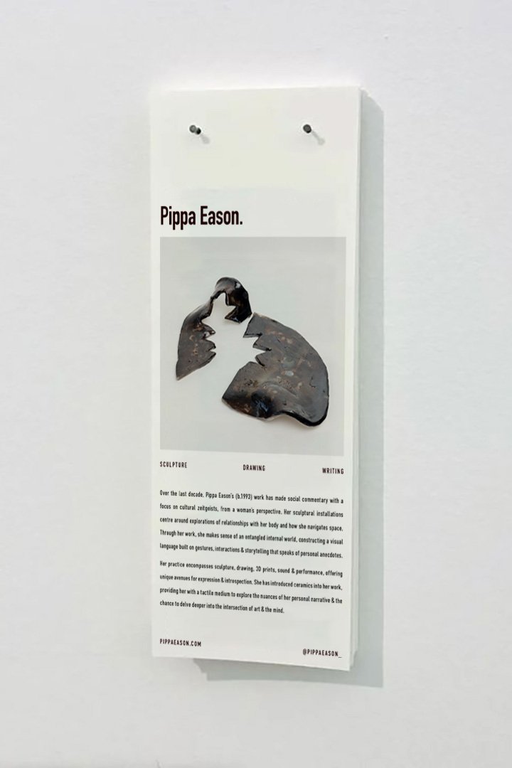 photo of an exhibition with vinyl logo on gallery wall