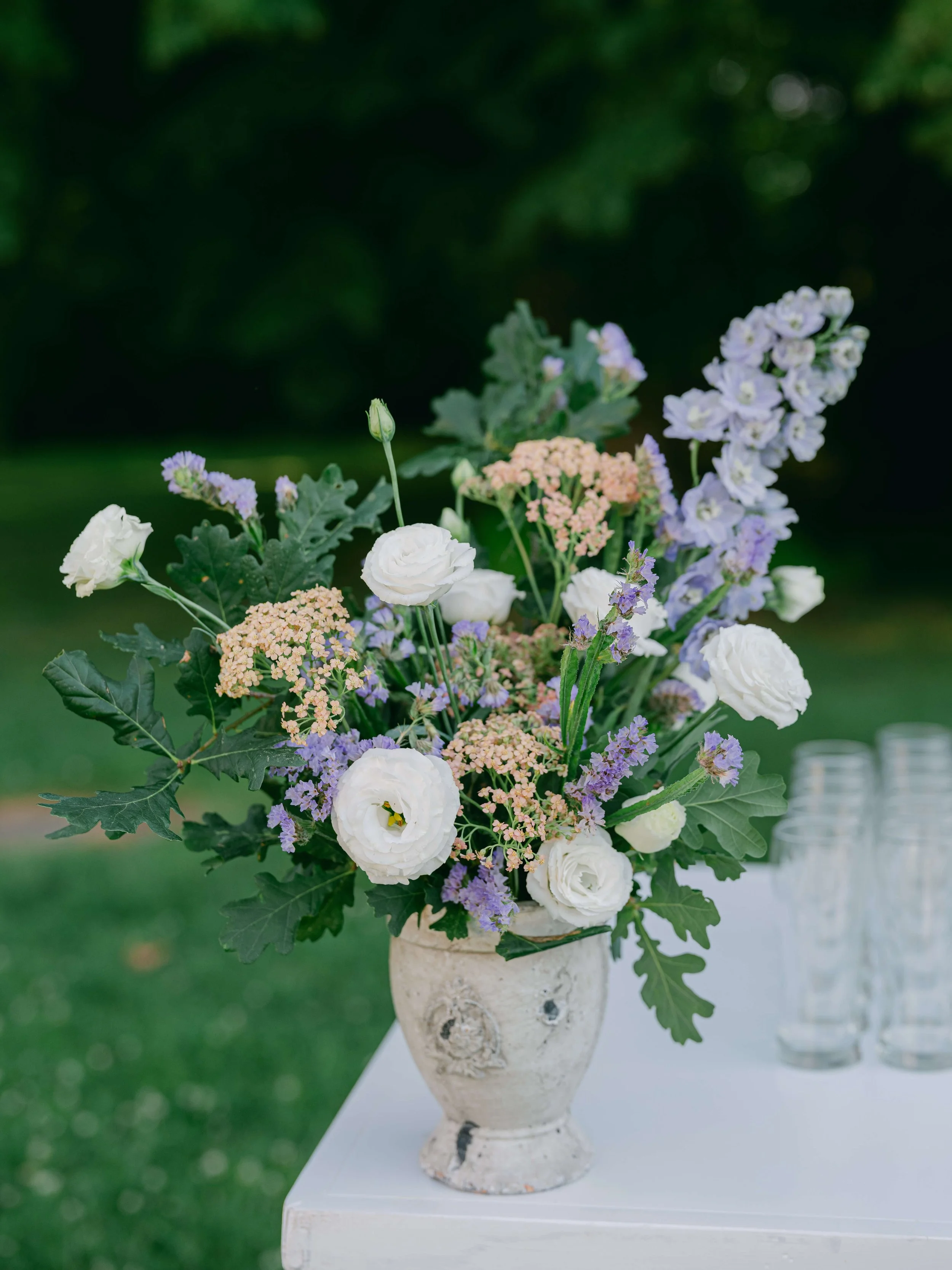 Garden-inspired floral arrangements decorating the outdoor cocktail bar
