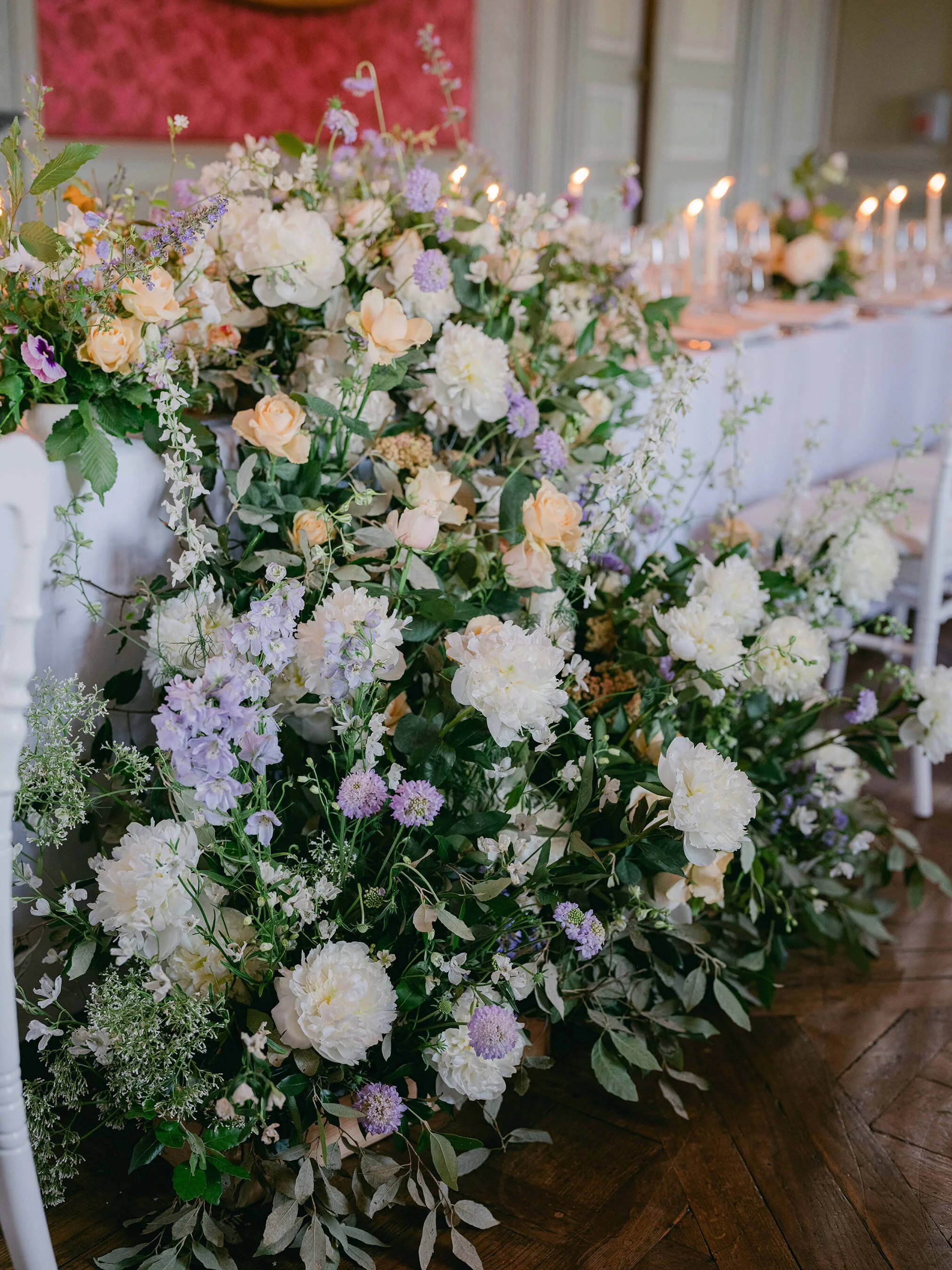 Cascading wedding flower installation beside the couple’s dinner table