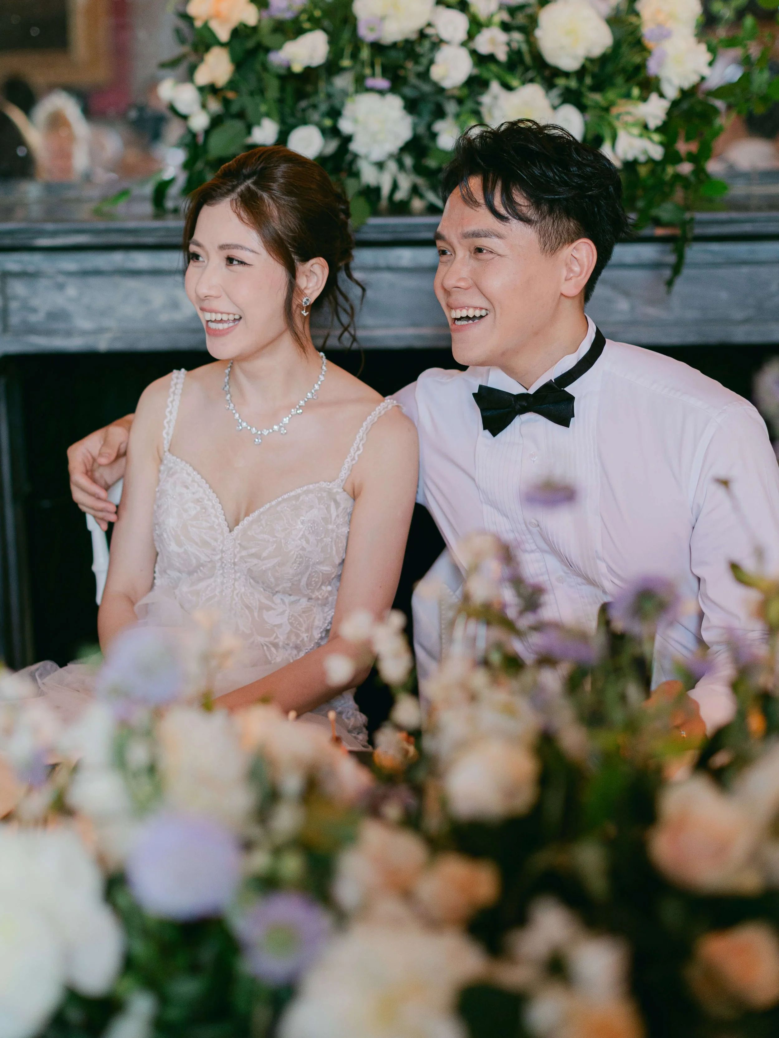 Helen and Randy seated together during their château wedding dinner
