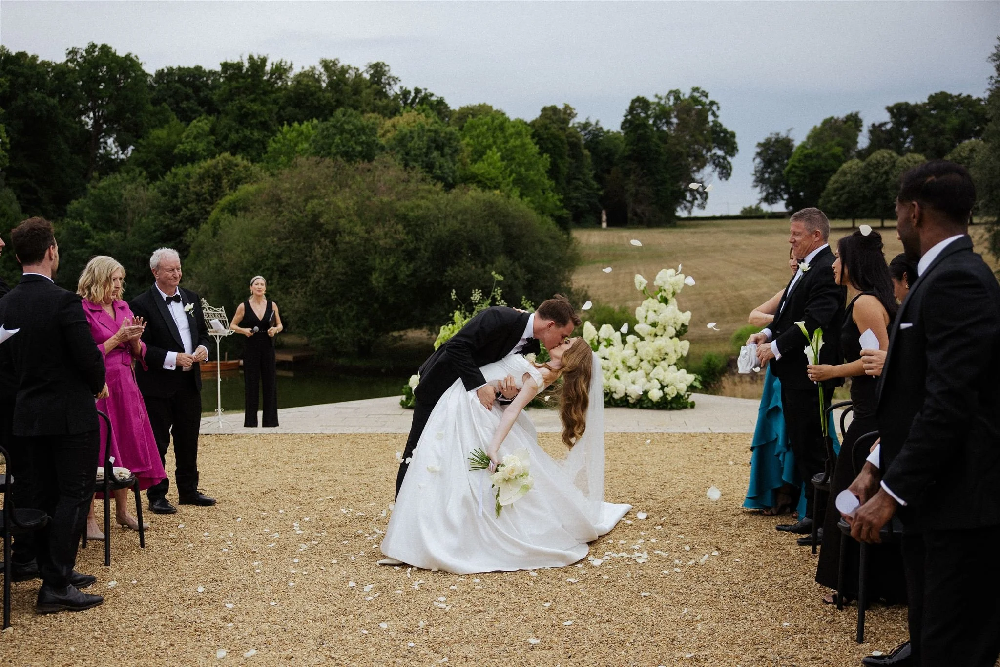 Loire Valley wedding ceremony at Château du Grand-Lucé with lush white hydrangeas framing the couple during a romantic outdoor moment.