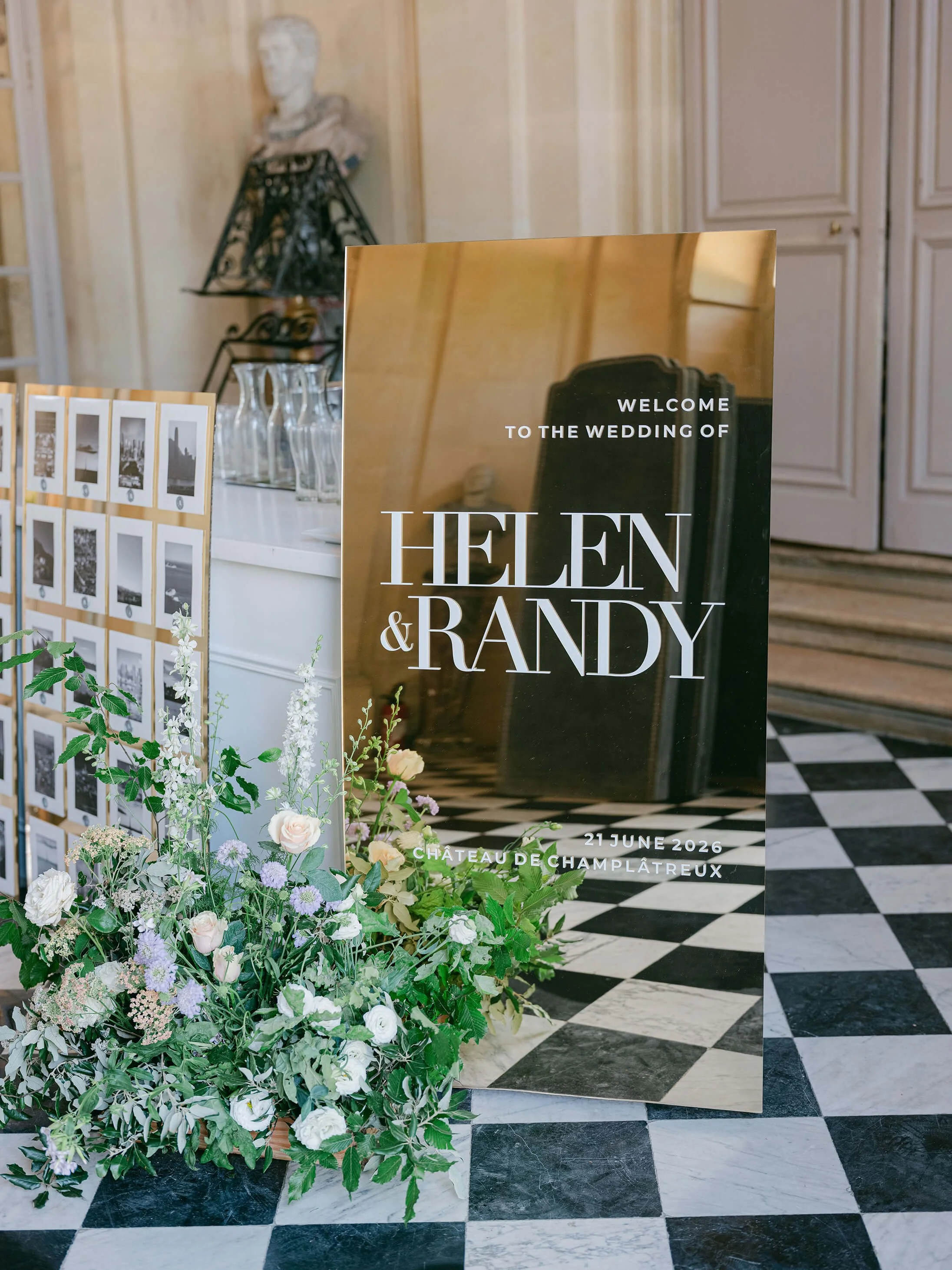 White wedding flowers lining the black-and-white marble entrance hall