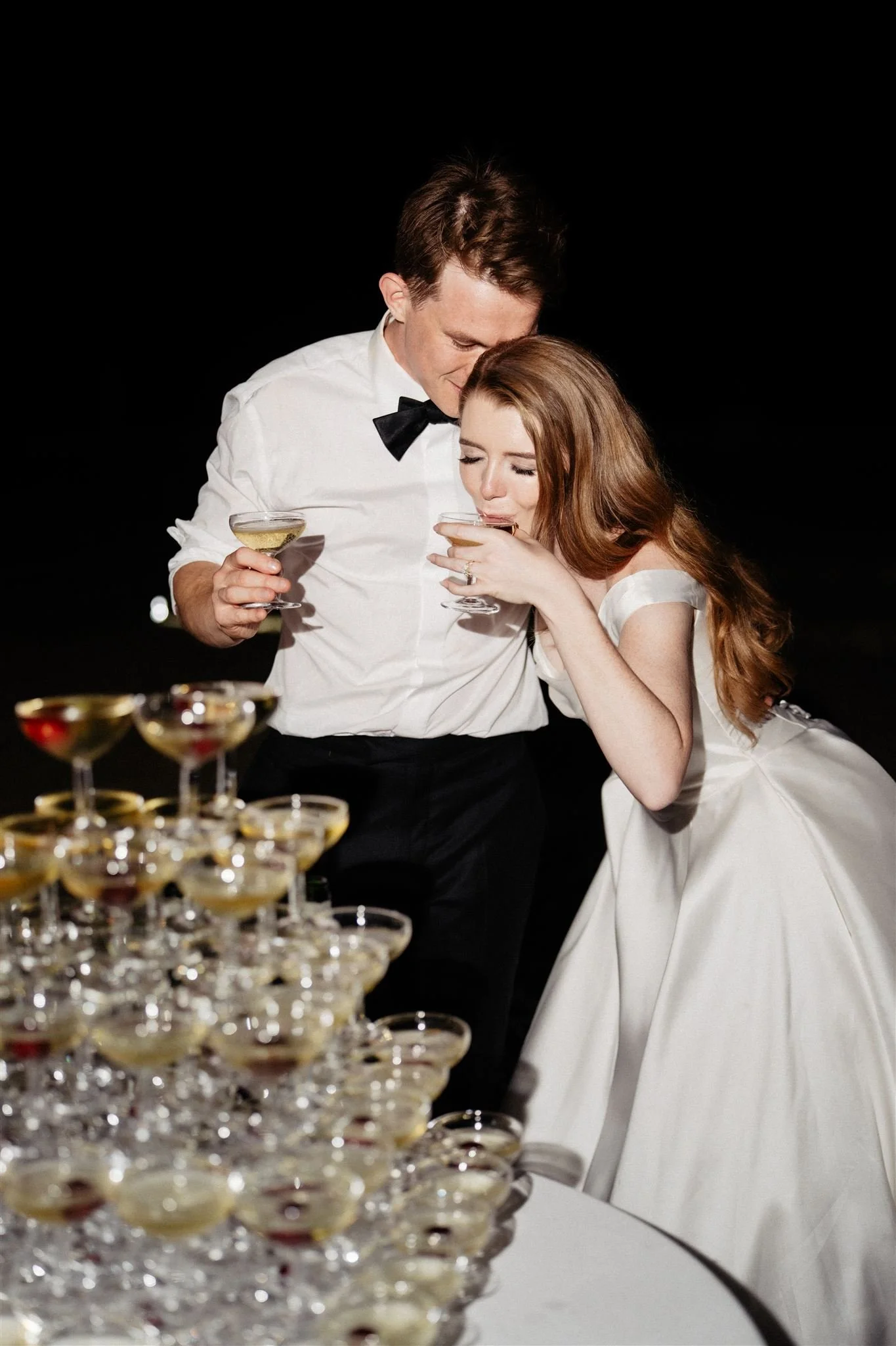 Evening celebration at Château du Grand-Lucé with a champagne tower and joyful post-ceremony moment.