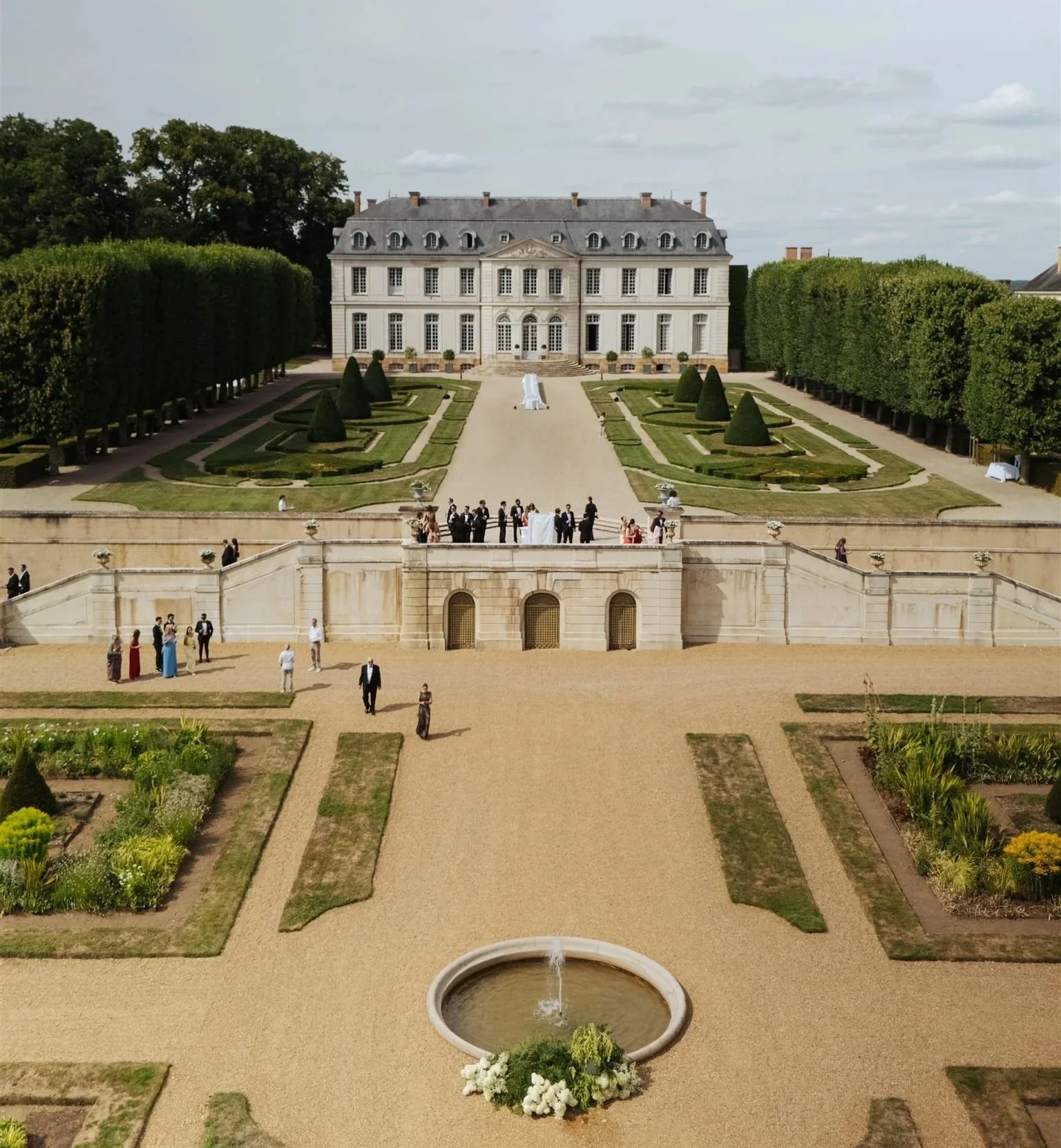 Aerial view of Château du Grand-Lucé and its formal French gardens during a luxury destination wedding weekend in the Loire Valley.