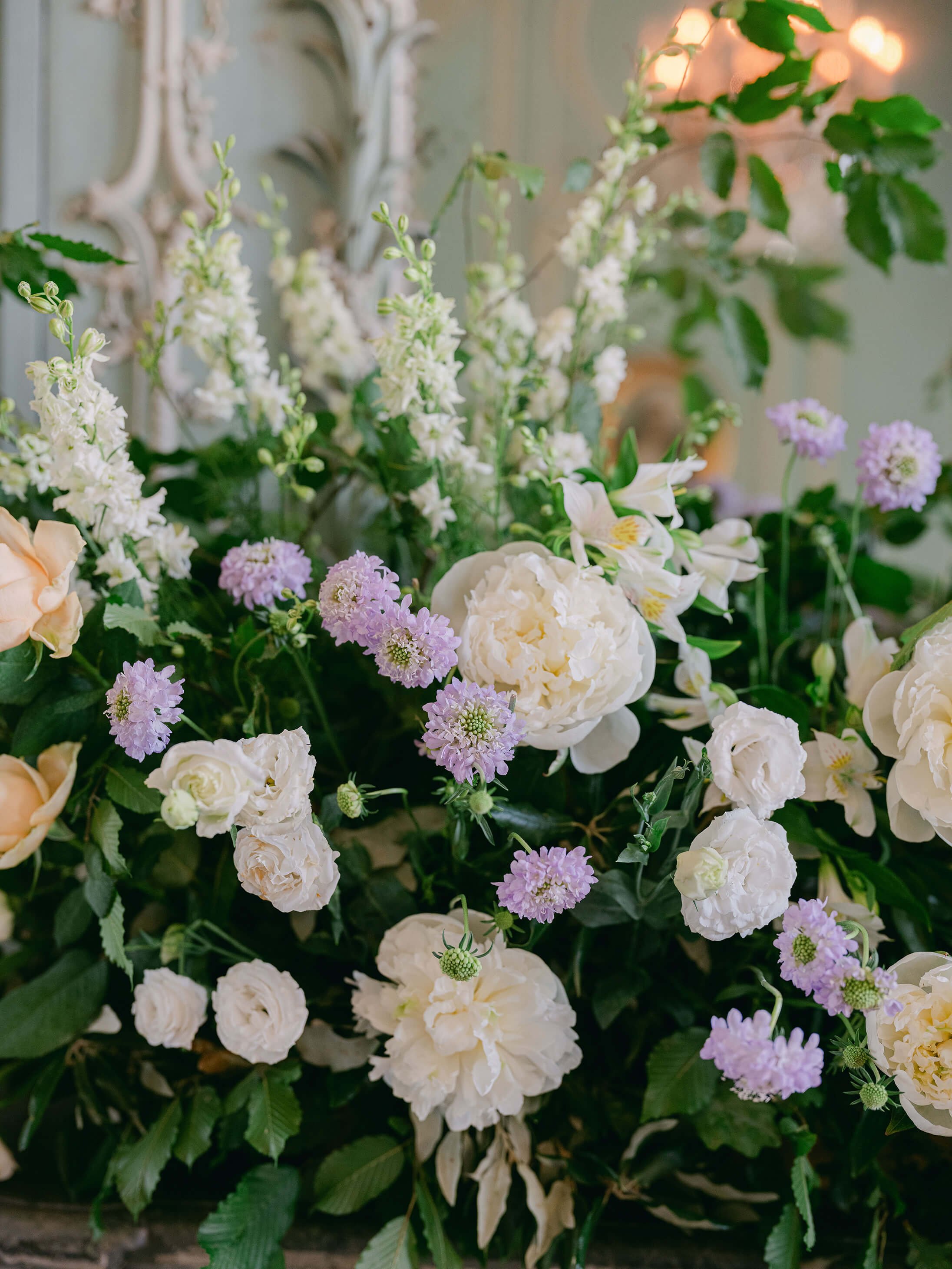 Garden-style floral arrangements placed along the château dinner tables