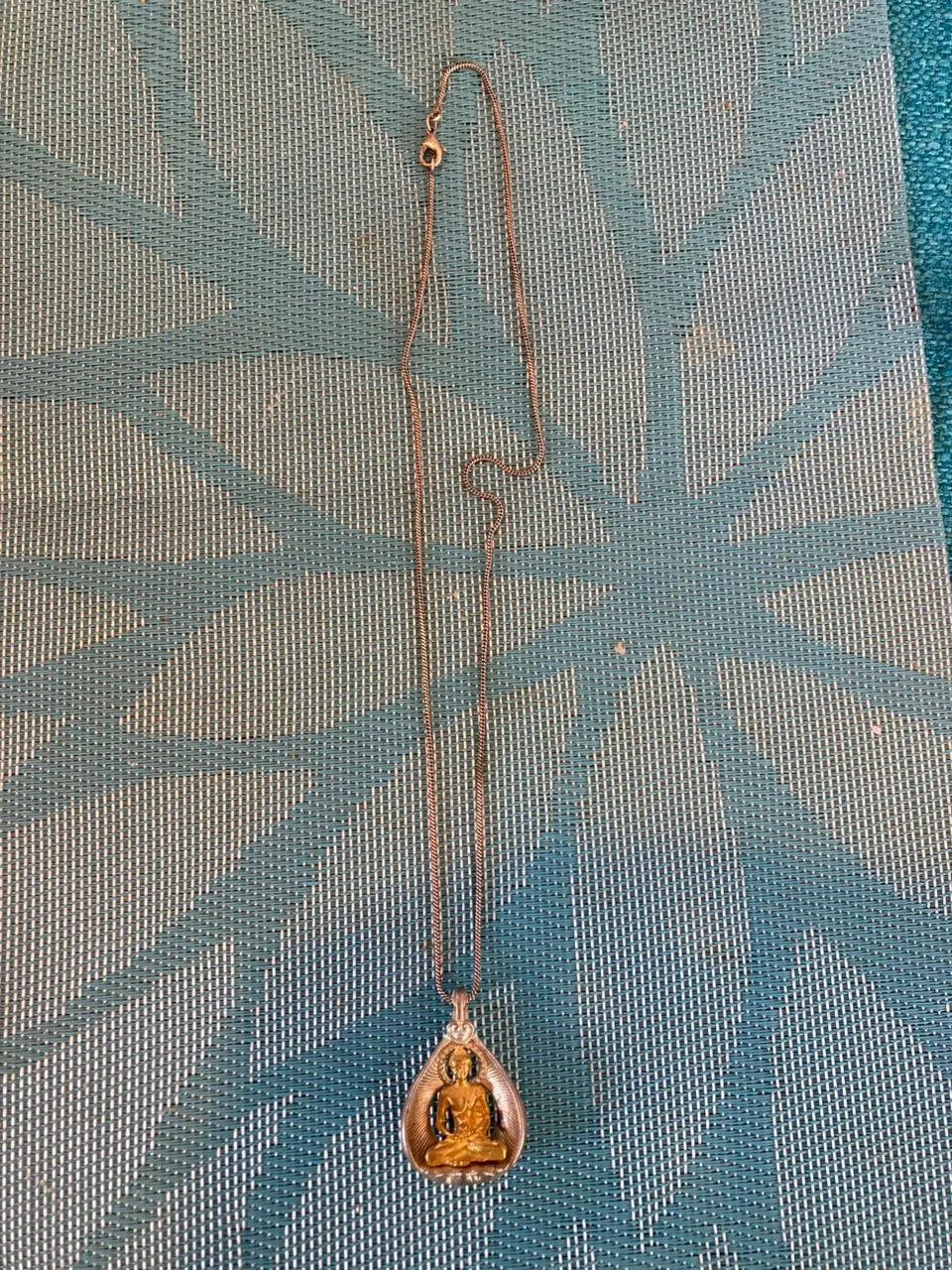 Buddha pendant on silver chain