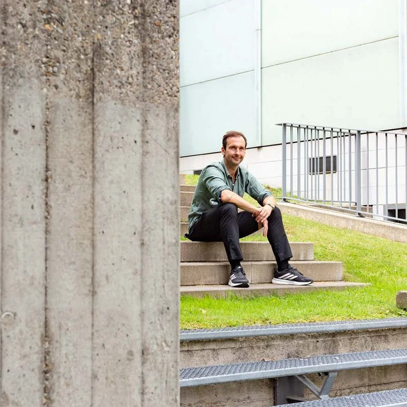 Thomas Ploch sitzend auf der Treppe vor dem Folkwang Museum in Essen