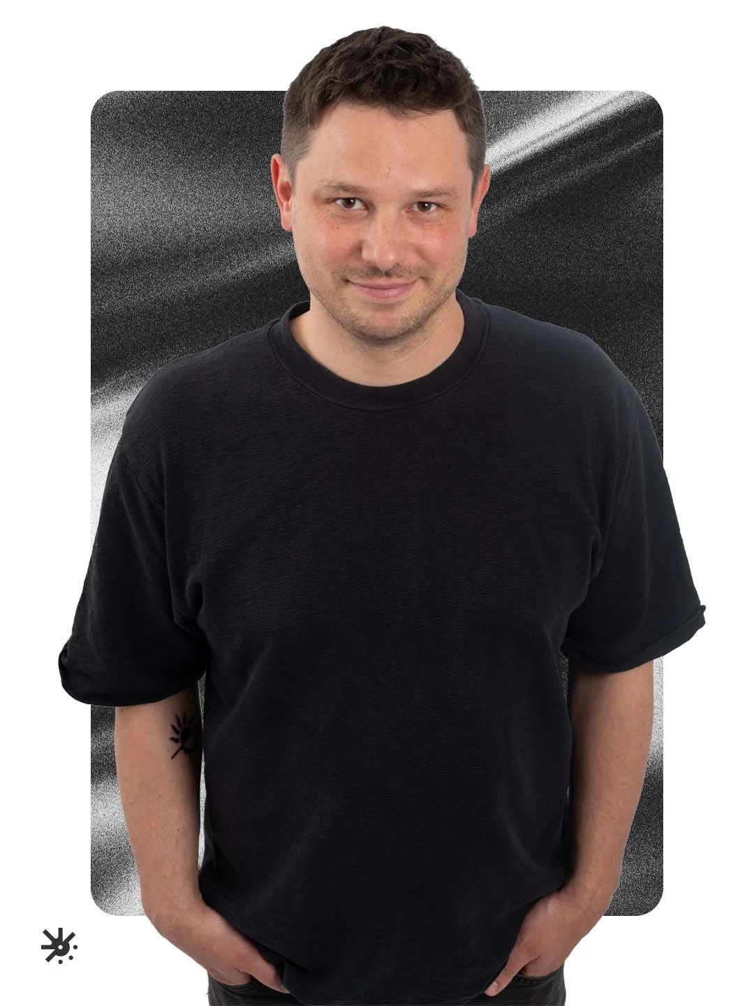 Portrait von Pascal Salewski. Er steht mit den Händen in der Tasche vor einem grauen Hintergrund mit Verlauf