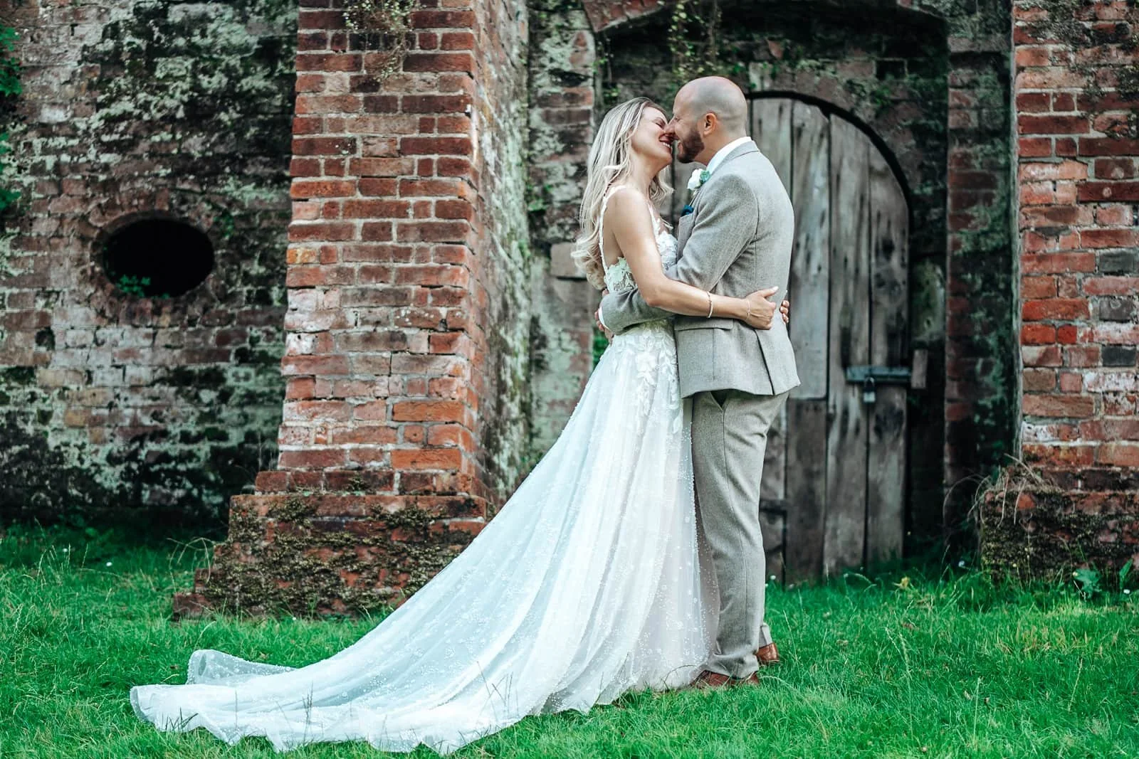 Couple kissing during portrait shots in Ufton Court Wedding venue gardens