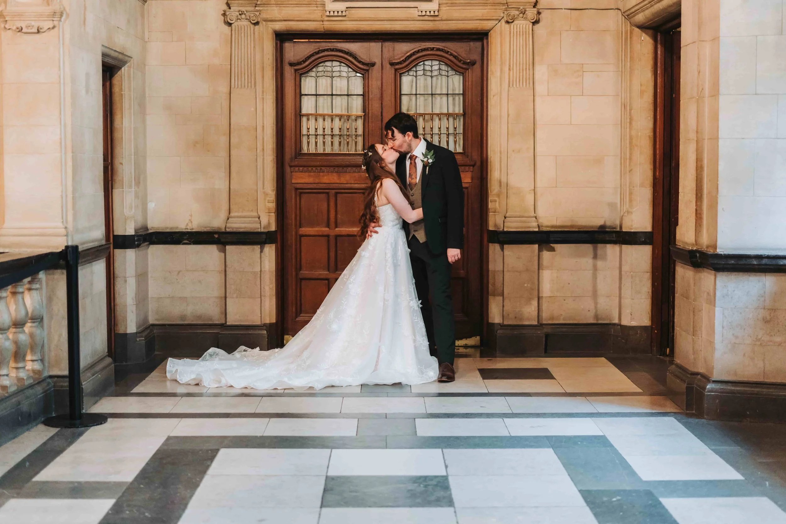 Candid moment in the historic corridors of Oxford Town Hall on a wedding day