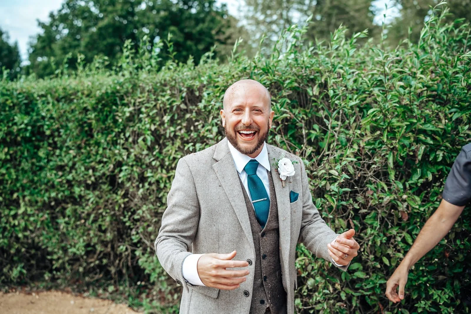 Groom covered in Confetti after wedding ceremony at Ufton Court