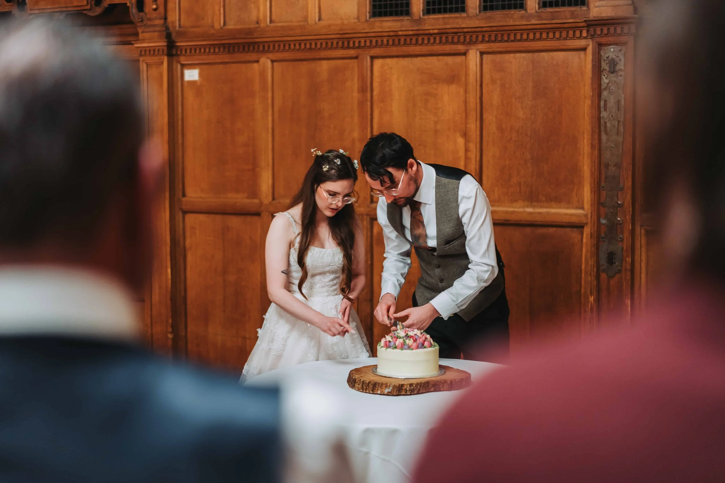 Wedding cake cutting during the reception at Oxford Town Hall