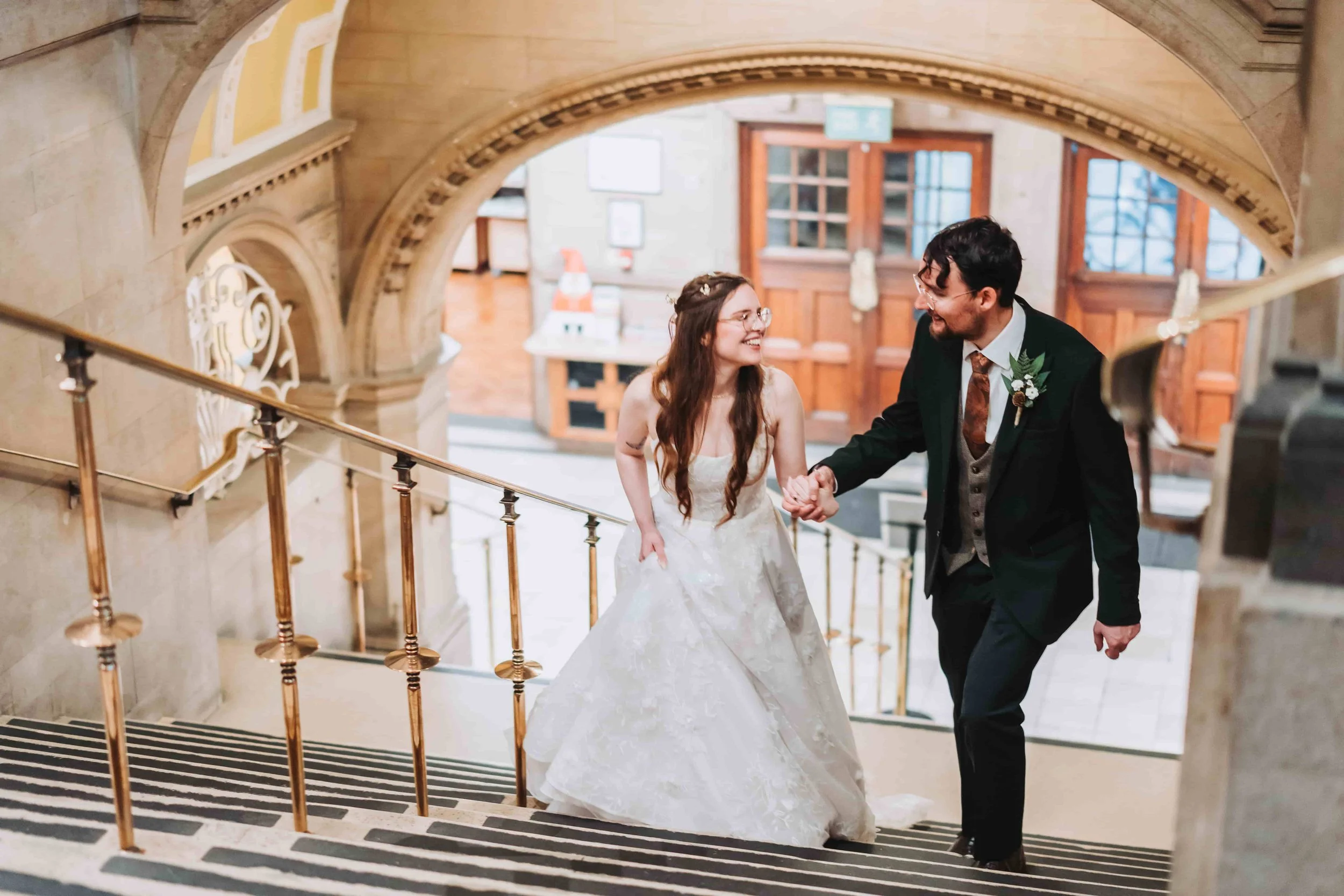 Rebecca and Bono on the iconic stairs at Oxford Town Hall on their wedding day