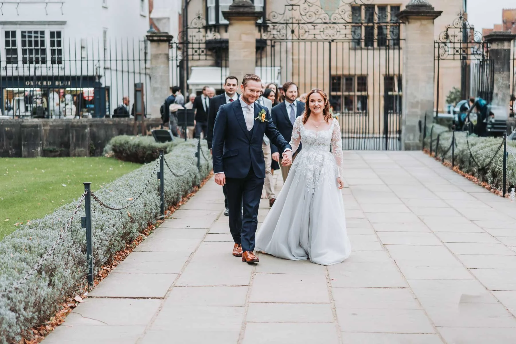 bride-groom-walking-through-christ-church-gardens-oxfordshire.jpg